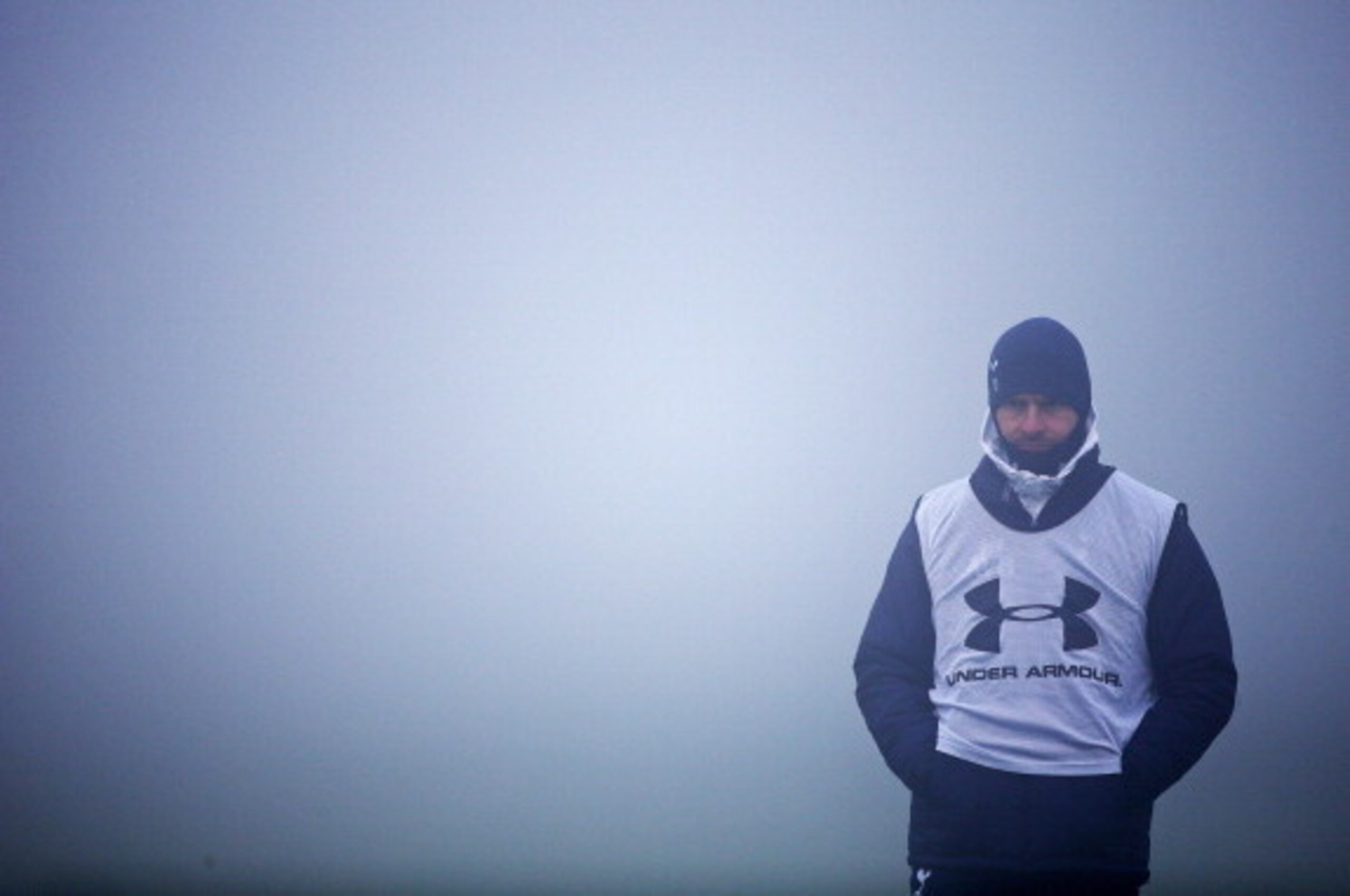 ENFIELD, ENGLAND - DECEMBER 11: Manager Andre Villas-Boas keeps an eye on the session in the fog during Tottenham Hotspur training session ahead of their UEFA Europa League group match against FC Anji at Hotspur Way on December 11, 2013 in London, England