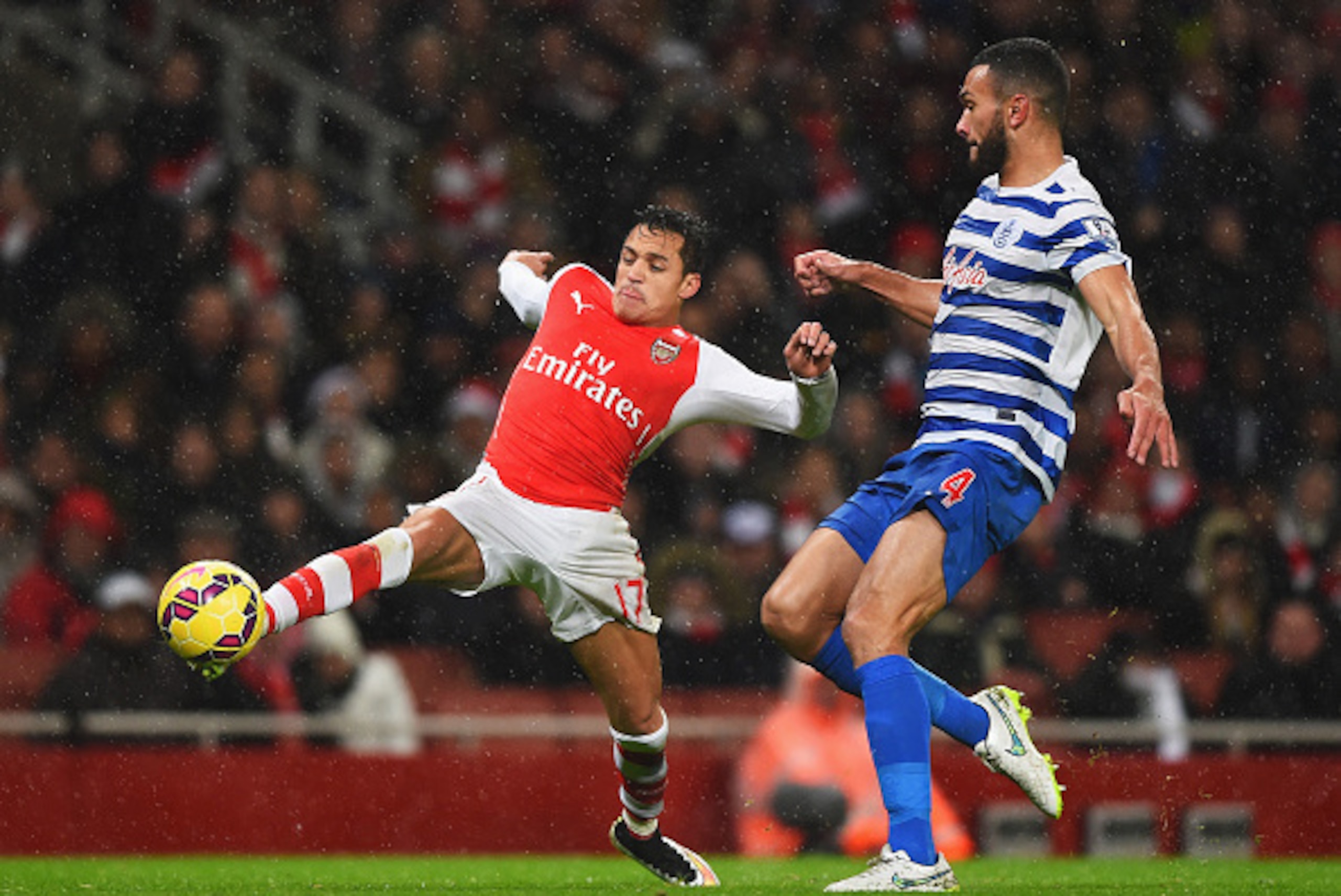 LONDON, ENGLAND - DECEMBER 26: Alexis Sanchez of Arsenal is closed down by Steven Caulker of QPR during the Barclays Premier League match between Arsenal and Queens Park Rangers at Emirates Stadium on December 26, 2014 in London, England. (Photo by Shaun LONDON, ENGLAND - DECEMBER 26: Alexis Sanchez of Arsenal is closed down by Steven Caulker of QPR during the Barclays Premier League match between Arsenal and Queens Park Rangers at Emirates Stadium on December 26, 2014 in London, England. (Photo by Shaun