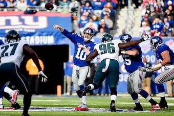 EAST RUTHERFORD, NJ - DECEMBER 28:  Eli Manning #10 of the New York Giants passes against the Philadelphia Eagles in the first quarter during a game at MetLife Stadium on December 28, 2014 in East Rutherford, New Jersey.  (Photo by Alex Goodlett/Getty Ima