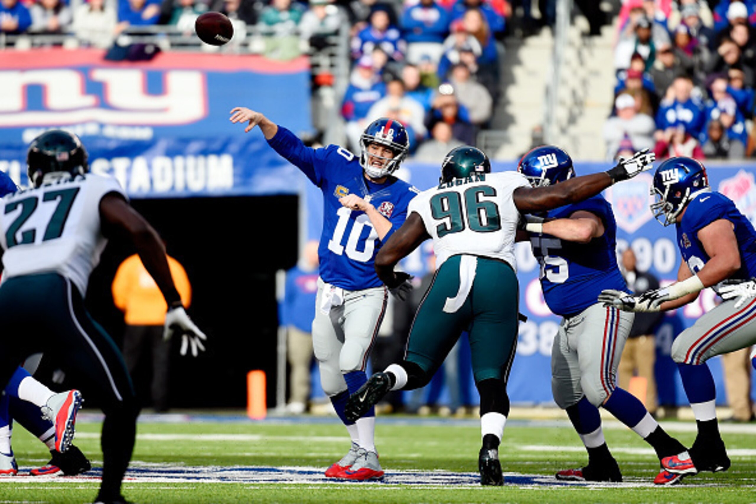 EAST RUTHERFORD, NJ - DECEMBER 28:  Eli Manning #10 of the New York Giants passes against the Philadelphia Eagles in the first quarter during a game at MetLife Stadium on December 28, 2014 in East Rutherford, New Jersey.  (Photo by Alex Goodlett/Getty Ima