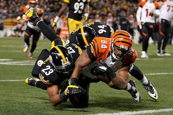 PITTSBURGH, PA - DECEMBER 28:  Jermaine Gresham #84 of the Cincinnati Bengals dives for a touchdown in front of Mike Mitchell #23 of the Pittsburgh Steelers during the third quarter at Heinz Field on December 28, 2014 in Pittsburgh, Pennsylvania.  (Photo 