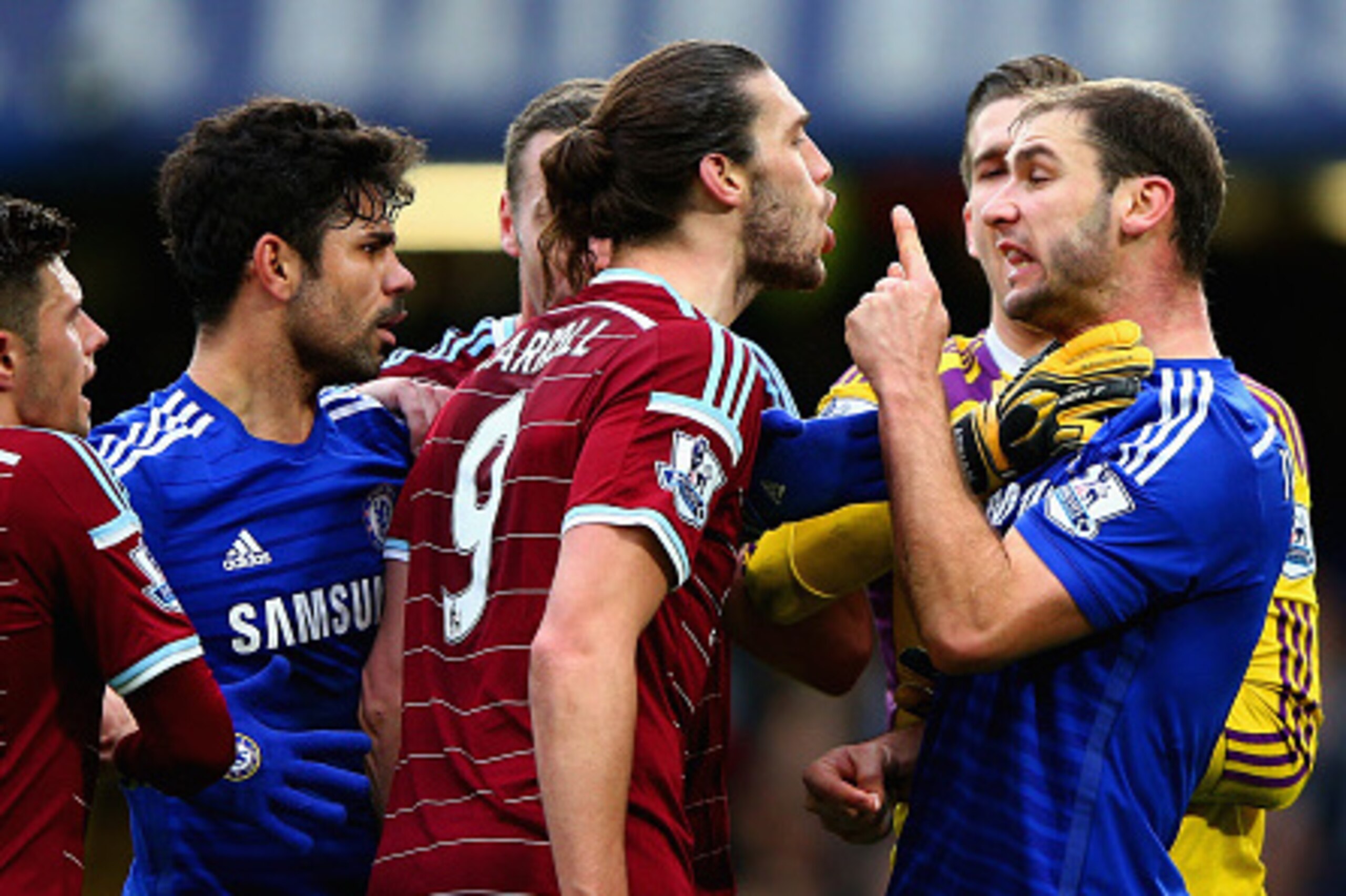 LONDON, ENGLAND - DECEMBER 26:  Andy Carroll of West Ham clashes with Branislav Ivanovic of Chelsea during the Barclays Premier League match between Chelsea and West Ham United at Stamford Bridge on December 26, 2014 in London, England.  (Photo by Ian Wal