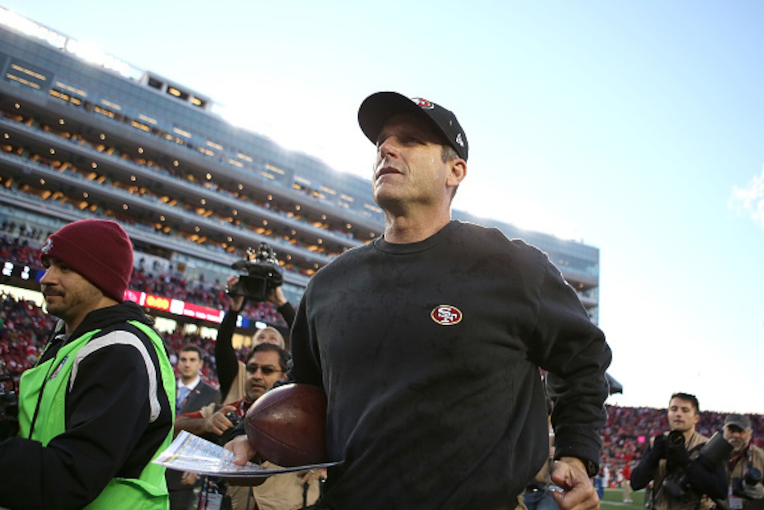 SANTA CLARA, CA - DECEMBER 28: head coach Jim Harbaugh of the San Francisco 49ers leaves the field after their win over the Arizona Cardinals at Levi's Stadium on December 28, 2014 in Santa Clara, California. (Photo by Don Feria/Getty Images) SANTA CLARA, CA - DECEMBER 28: head coach Jim Harbaugh of the San Francisco 49ers leaves the field after their win over the Arizona Cardinals at Levi's Stadium on December 28, 2014 in Santa Clara, California. (Photo by Don Feria/Getty Images)