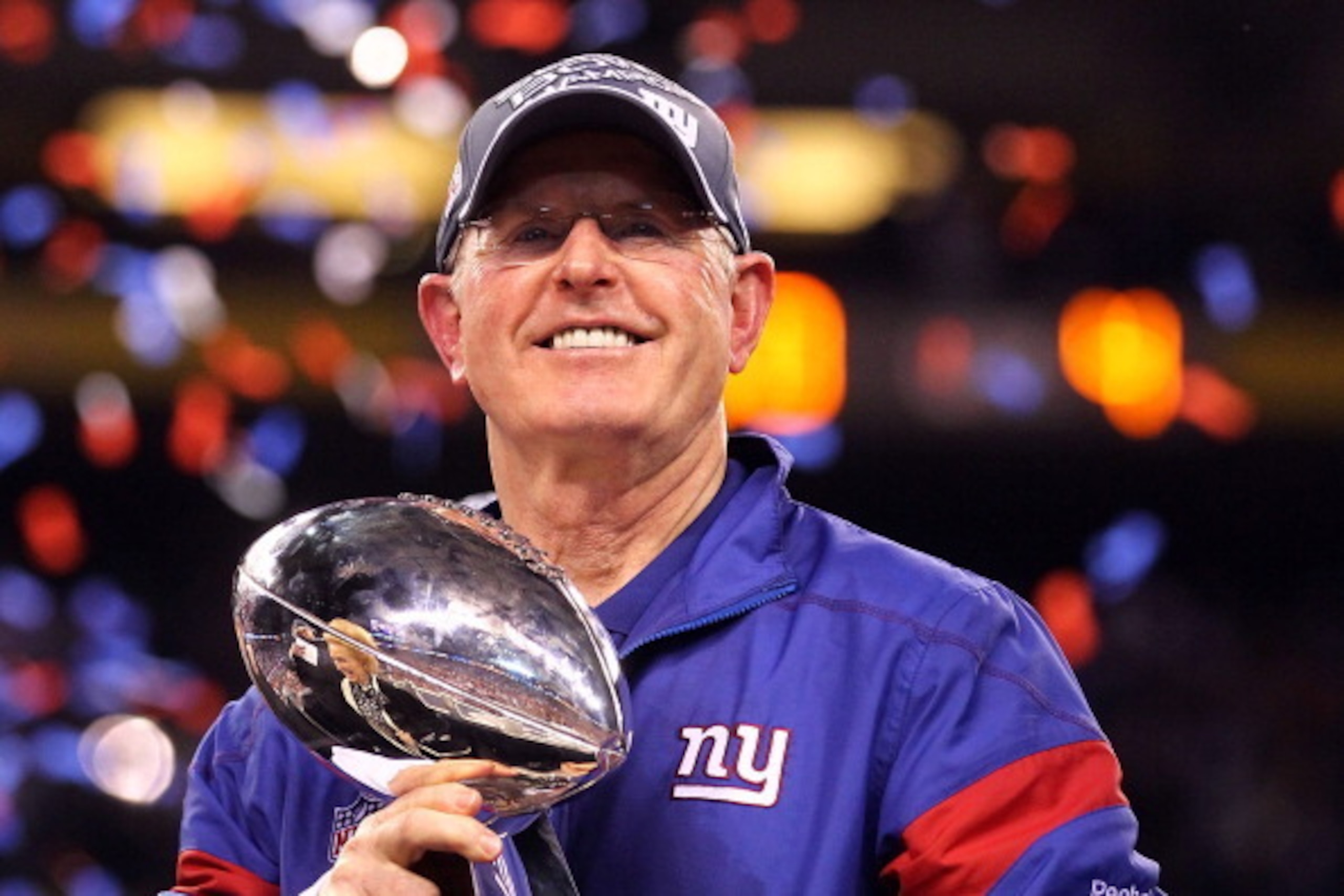 INDIANAPOLIS, IN - FEBRUARY 05:  Head coach Tom Coughlin of the New York Giants celebrates with the Vince Lombardi Trophy after defeating the New England Patriots in Super Bowl XLVI at Lucas Oil Stadium on February 5, 2012 in Indianapolis, Indiana. The Ne