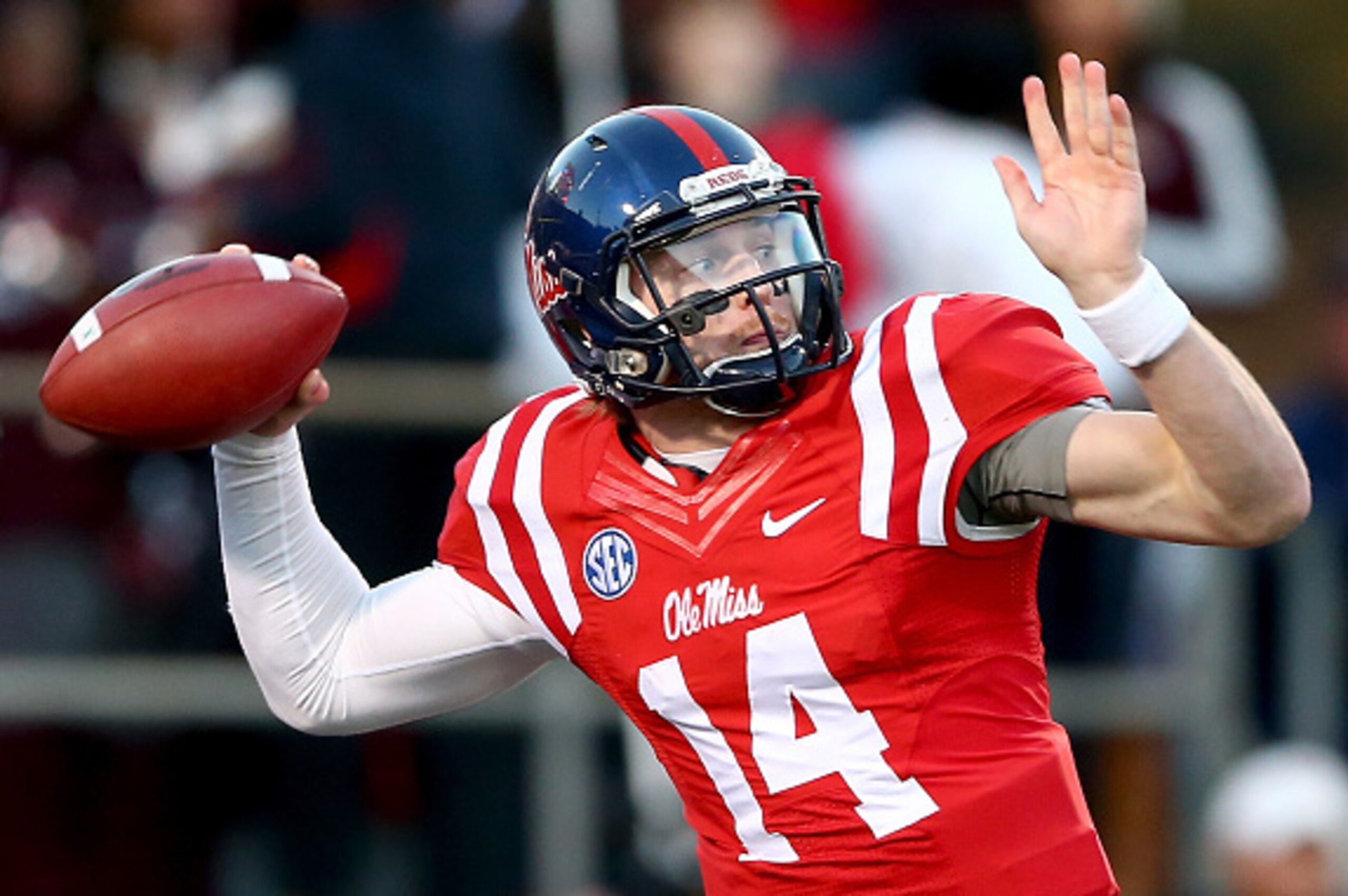 OXFORD, MS - NOVEMBER 29:  Bo Wallace #14 of the Mississippi Rebels drops back to pass against the Mississippi State Bulldogs during their game at Vaught-Hemingway Stadium on November 29, 2014 in Oxford, Mississippi.  (Photo by Streeter Lecka/Getty Images