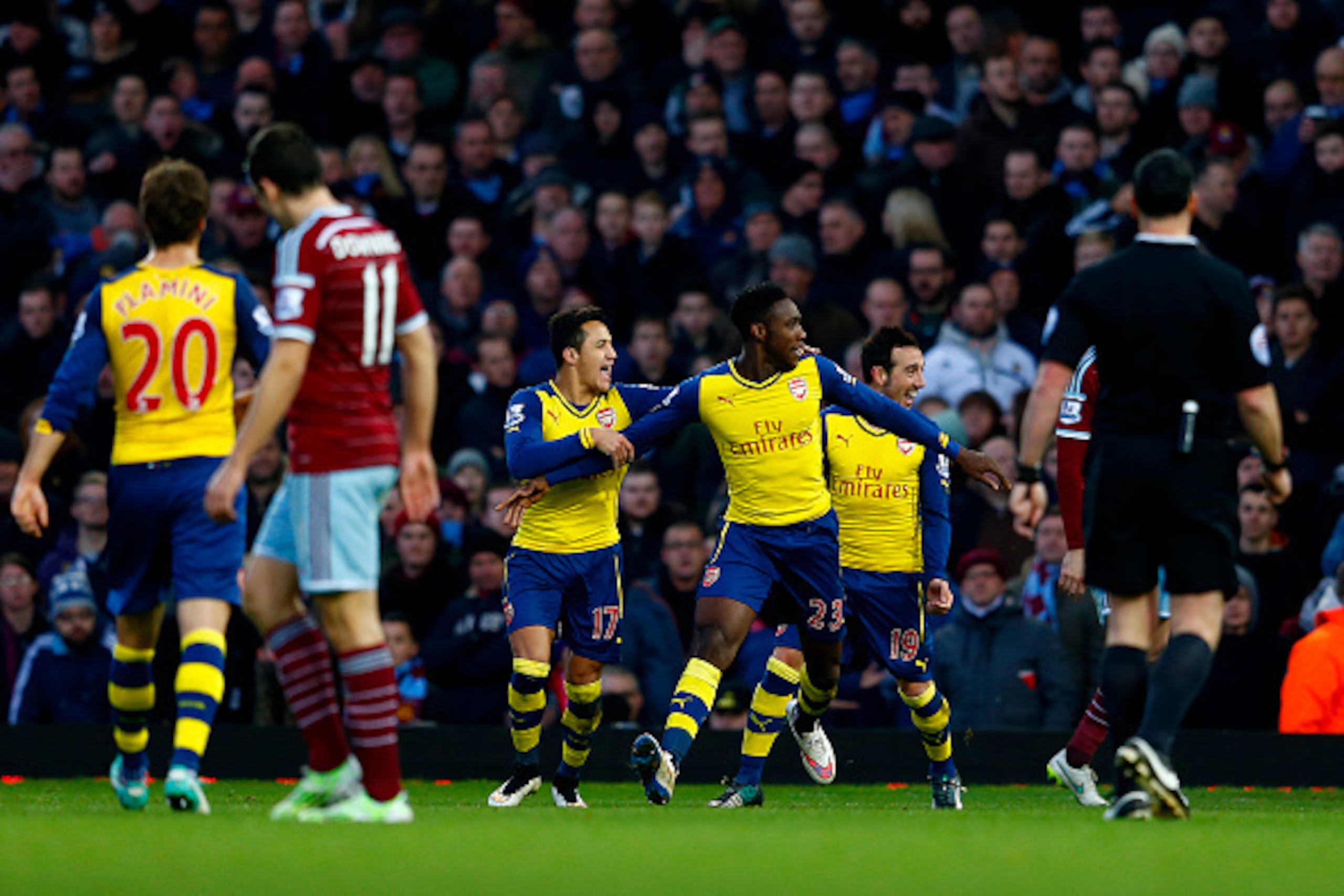 LONDON, ENGLAND - DECEMBER 28:  Danny Welbeck of Arsenal celebrates with team-mates after scoring his team's second goal during the Barclays Premier League match between West Ham United and Arsenal at Boleyn Ground on December 28, 2014 in London, England.