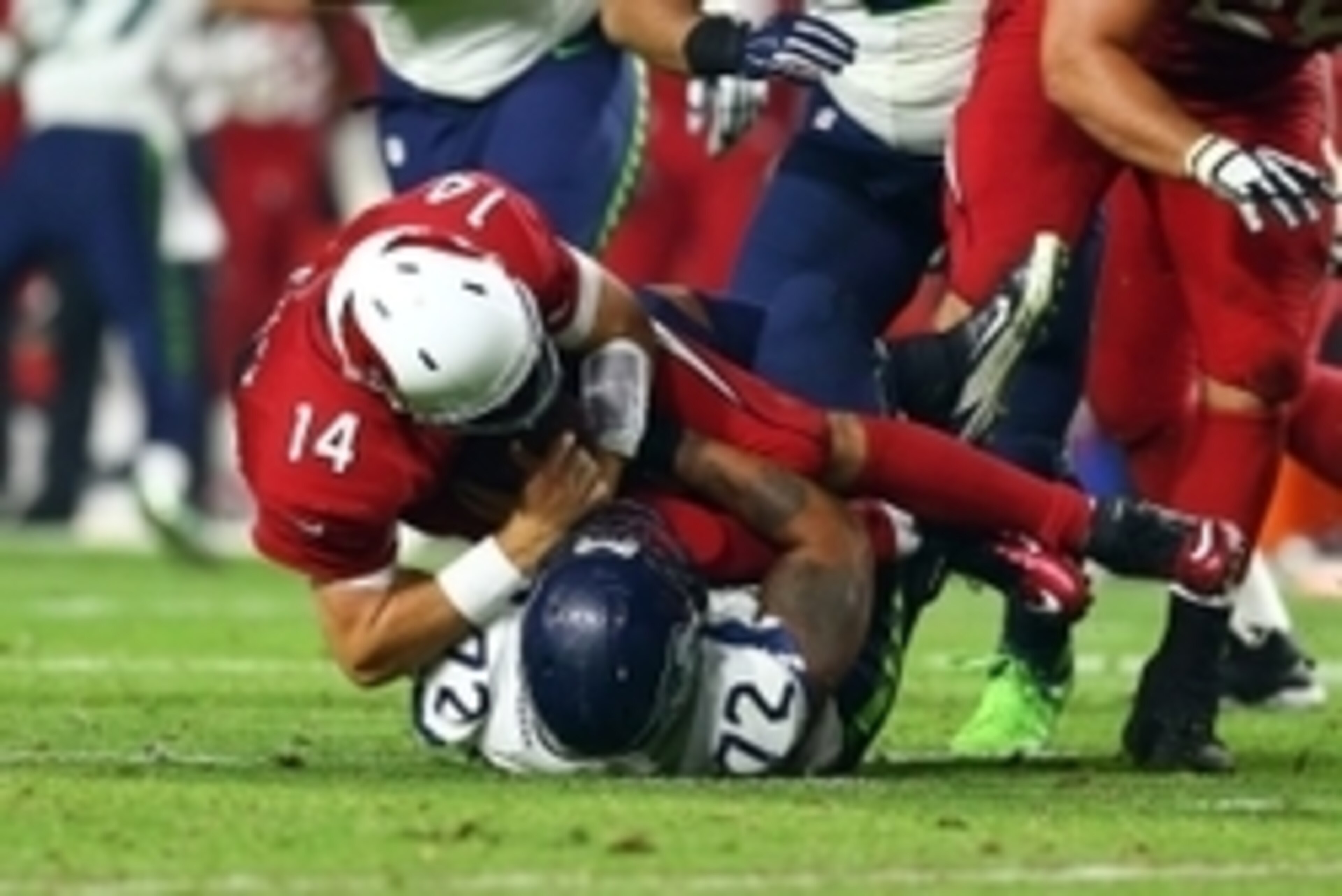 Dec 21, 2014; Glendale, AZ, USA; Arizona Cardinals quarterback Ryan Lindley (14) is sacked by Seattle Seahawks defensive end Michael Bennett (72) at University of Phoenix Stadium. The Seahawks defeated the Cardinals 35-6. Mandatory Credit: Mark J. Rebilas