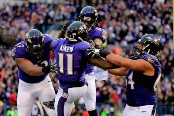 BALTIMORE, MD - DECEMBER 28:  Wide receiver Kamar Aiken #11 of the Baltimore Ravens celebrates with teammates after catching a fourth quarter touchdown against the Cleveland Browns at M&T Bank Stadium on December 28, 2014 in Baltimore, Maryland.  (Photo b