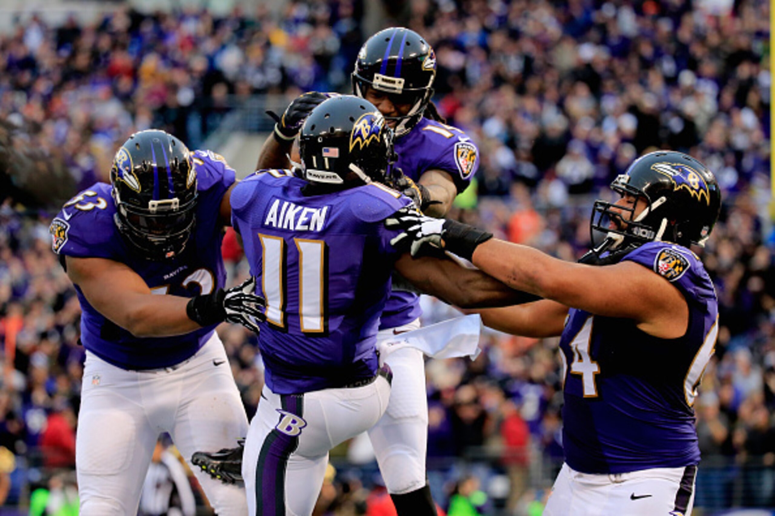 BALTIMORE, MD - DECEMBER 28:  Wide receiver Kamar Aiken #11 of the Baltimore Ravens celebrates with teammates after catching a fourth quarter touchdown against the Cleveland Browns at M&T Bank Stadium on December 28, 2014 in Baltimore, Maryland.  (Photo b