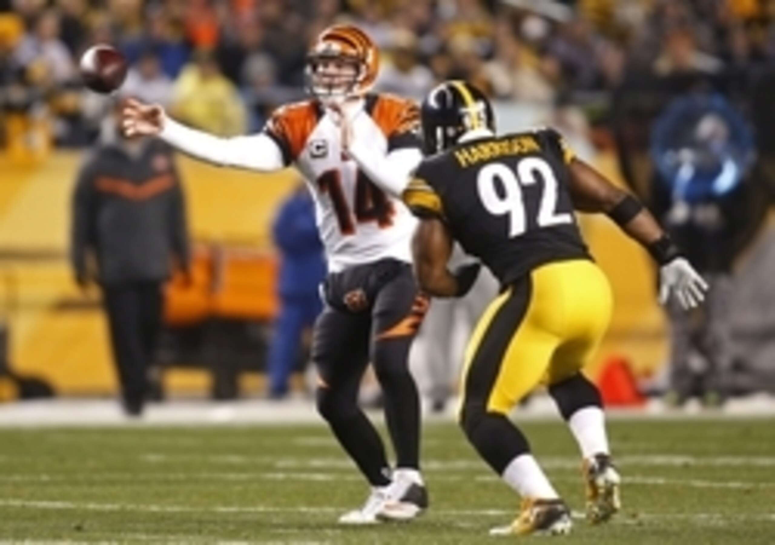 Dec 28, 2014; Pittsburgh, PA, USA; Cincinnati Bengals quarterback Andy Dalton (14) passes the ball under pressure from Pittsburgh Steelers outside linebacker James Harrison (92) during the first quarter at Heinz Field. Mandatory Credit: Charles LeClaire-U