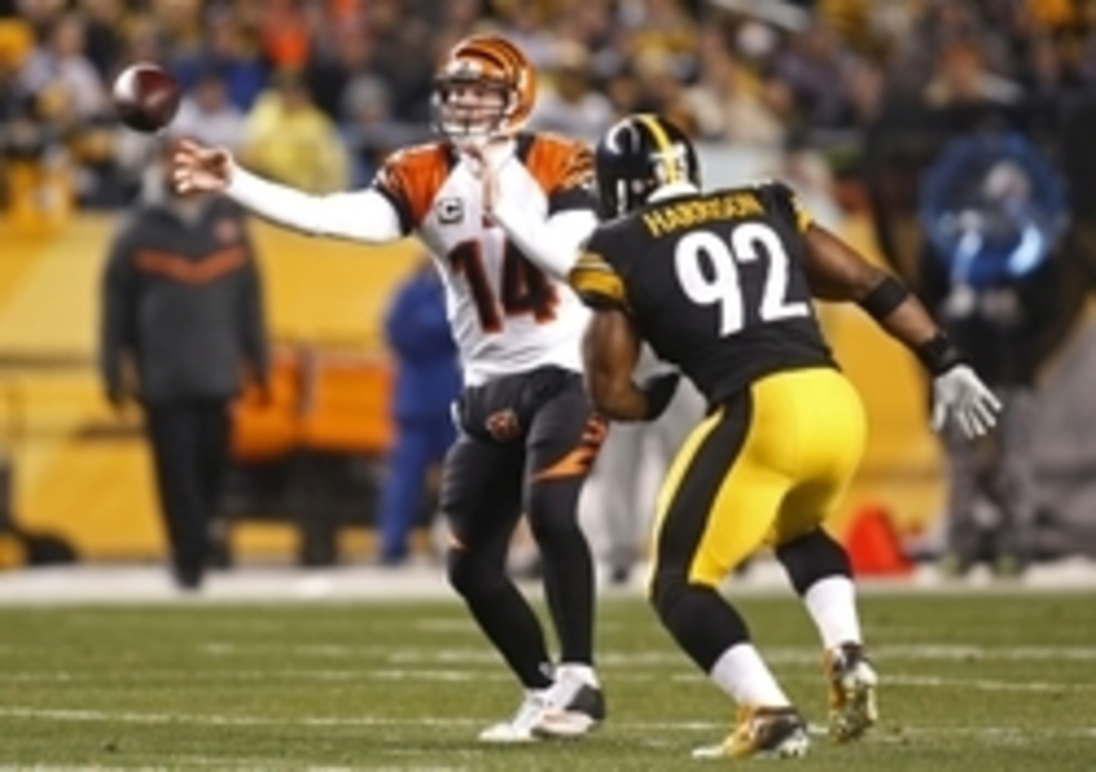 Dec 28, 2014; Pittsburgh, PA, USA; Cincinnati Bengals quarterback Andy Dalton (14) passes the ball under pressure from Pittsburgh Steelers outside linebacker James Harrison (92) during the first quarter at Heinz Field. Mandatory Credit: Charles LeClaire-U