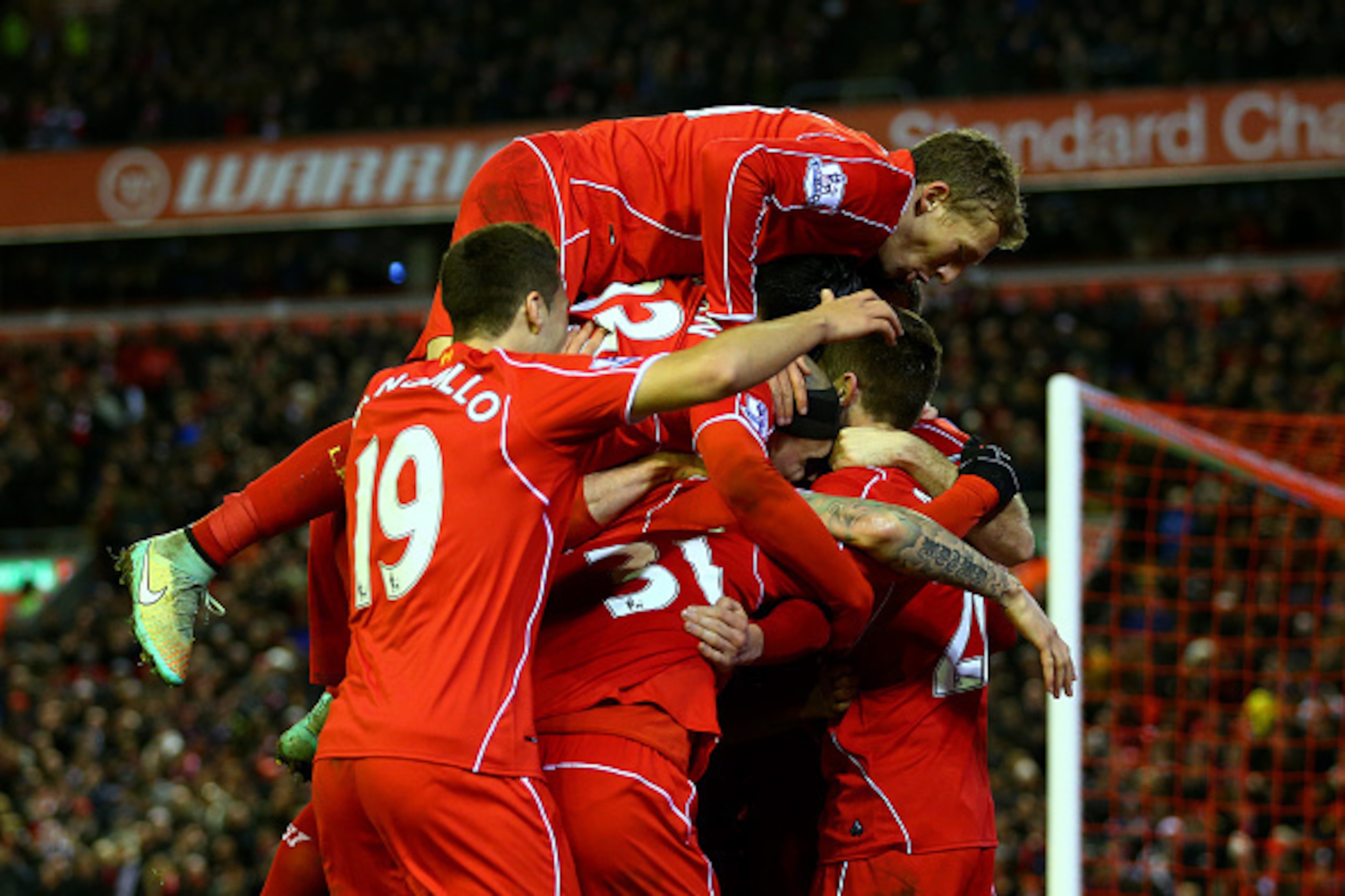 LIVERPOOL, ENGLAND - DECEMBER 29:  Adam Lallana of Liverpool celebrates with team-mates after scoring his team's second goal during the Barclays Premier League match between Liverpool and Swansea City at Anfield on December 29, 2014 in Liverpool, England.