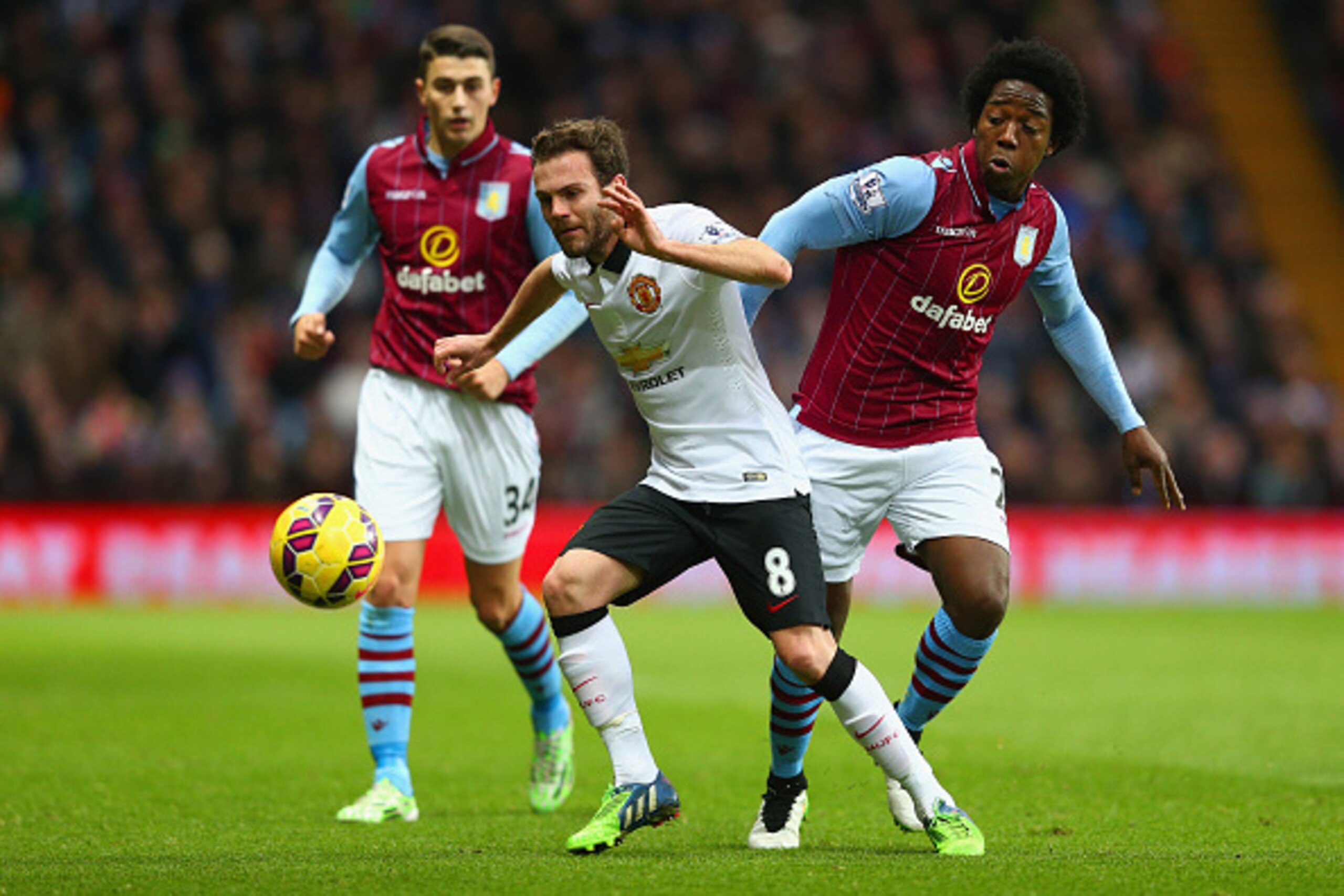 BIRMINGHAM, ENGLAND - DECEMBER 20: Juan Mata of Manchester United is tackled by Carlos Sanchez of Aston Villa  during the Barclays Premier League match between Aston Villa and Manchester United at Villa Park on December 20, 2014 in Birmingham, England.  (