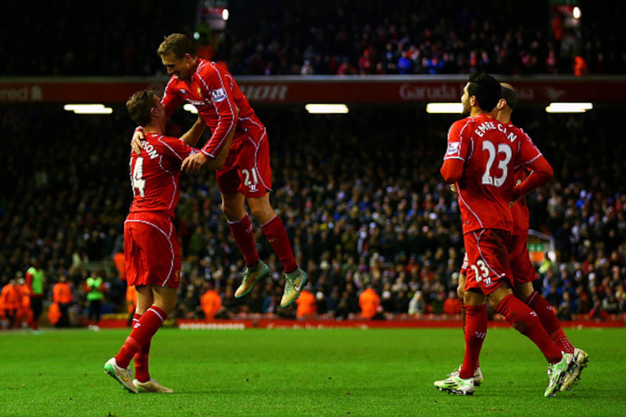 LIVERPOOL, ENGLAND - DECEMBER 29:  Jordan Henderson of Liverpool celebrates with team-mates after Jonjo Shelvey of Swansea City scored an own goal during the Barclays Premier League match between Liverpool and Swansea City at Anfield on December 29, 2014 