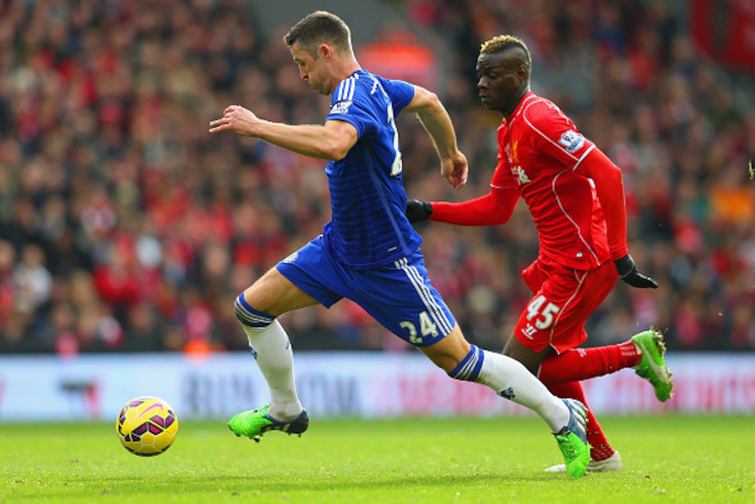 LIVERPOOL, ENGLAND - NOVEMBER 08:  Mario Balotelli of Liverpool closes down Gary Cahill of Chelsea during the Barclays Premier League match between Liverpool and Chelsea at Anfield on November 8, 2014 in Liverpool, England.  (Photo by Alex Livesey/Getty I