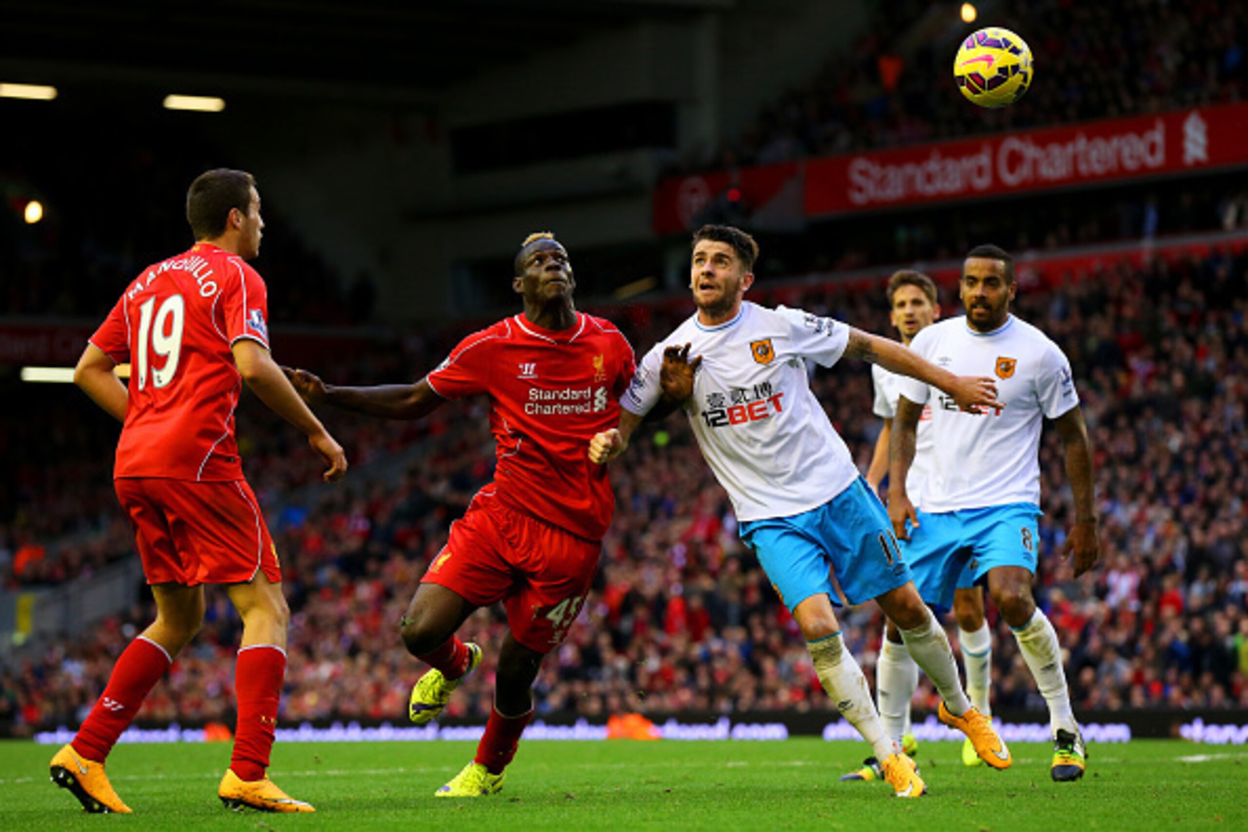 LIVERPOOL, ENGLAND - OCTOBER 25:  Mario Balotelli of Liverpool battles for the ball with Robbie Brady of Hull City during the Barclays Premier League match between Liverpool and Hull City at Anfield on October 25, 2014 in Liverpool, England.  (Photo by Al
