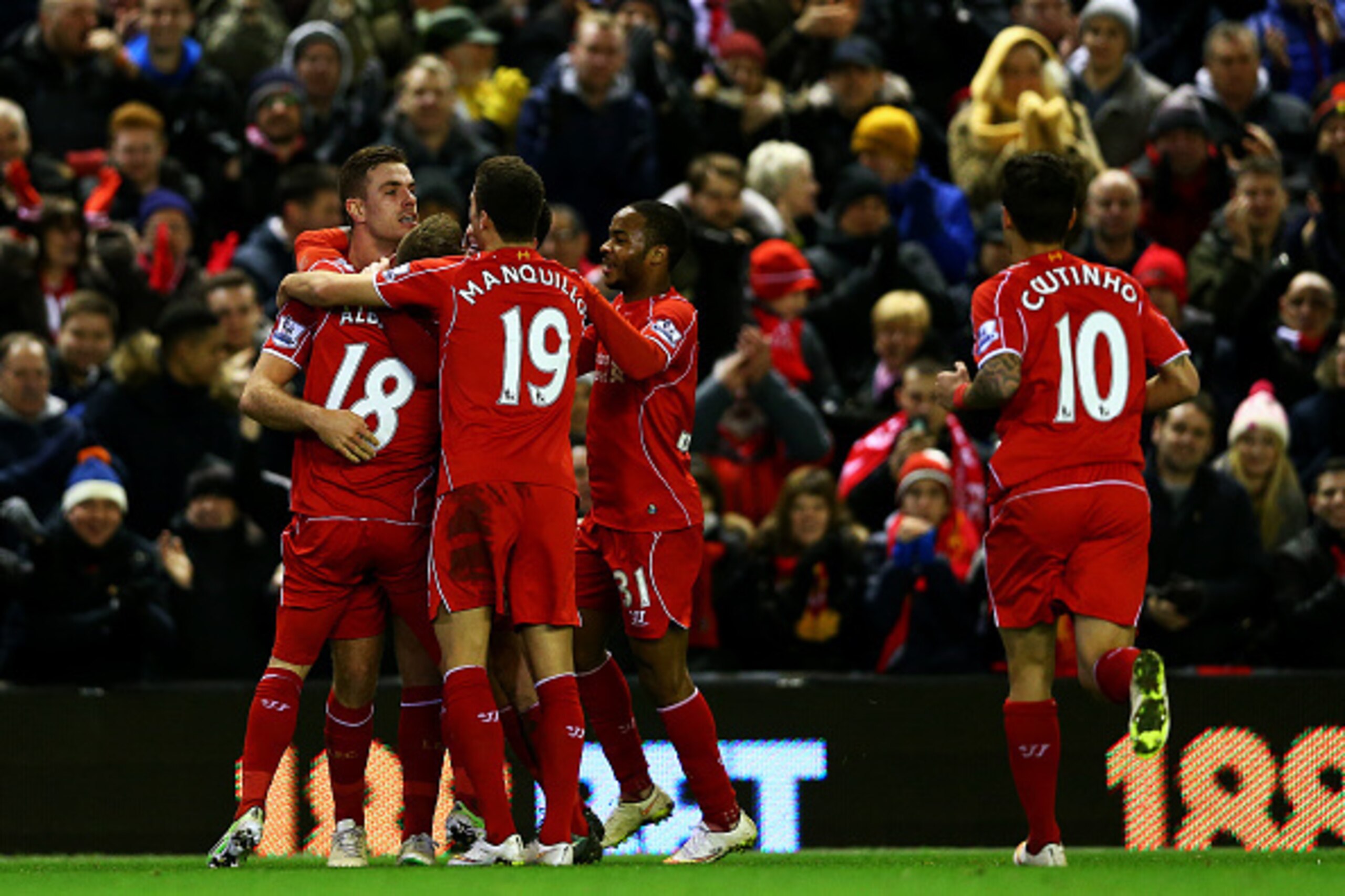 LIVERPOOL, ENGLAND - DECEMBER 29:  Alberto Moreno of Liverpool celebrates with team-mates after scoring the opening goal during the Barclays Premier League match between Liverpool and Swansea City at Anfield on December 29, 2014 in Liverpool, England.  (P