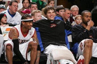 PHILADELPHIA - FEBRUARY  4:  (L-R) Allen Iverson #3, Kyle Korver #26 and Aaron McKie #8 of the Philadelphia 76ers look on from the bench against the Atlanta Hawks on February 4, 2005 at the Wachovia Center in Philadelphia, Pennsylvania.  The 76ers won 103