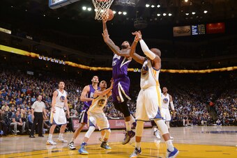 OAKLAND, CA - DECEMBER 22: DeMarcus Cousins #15 of the Sacramento Kings shoots against Marreese Speights #5 of the Golden State Warriors on December 22, 2014 at Oracle Arena in Oakland, California. NOTE TO USER: User expressly acknowledges and agrees that