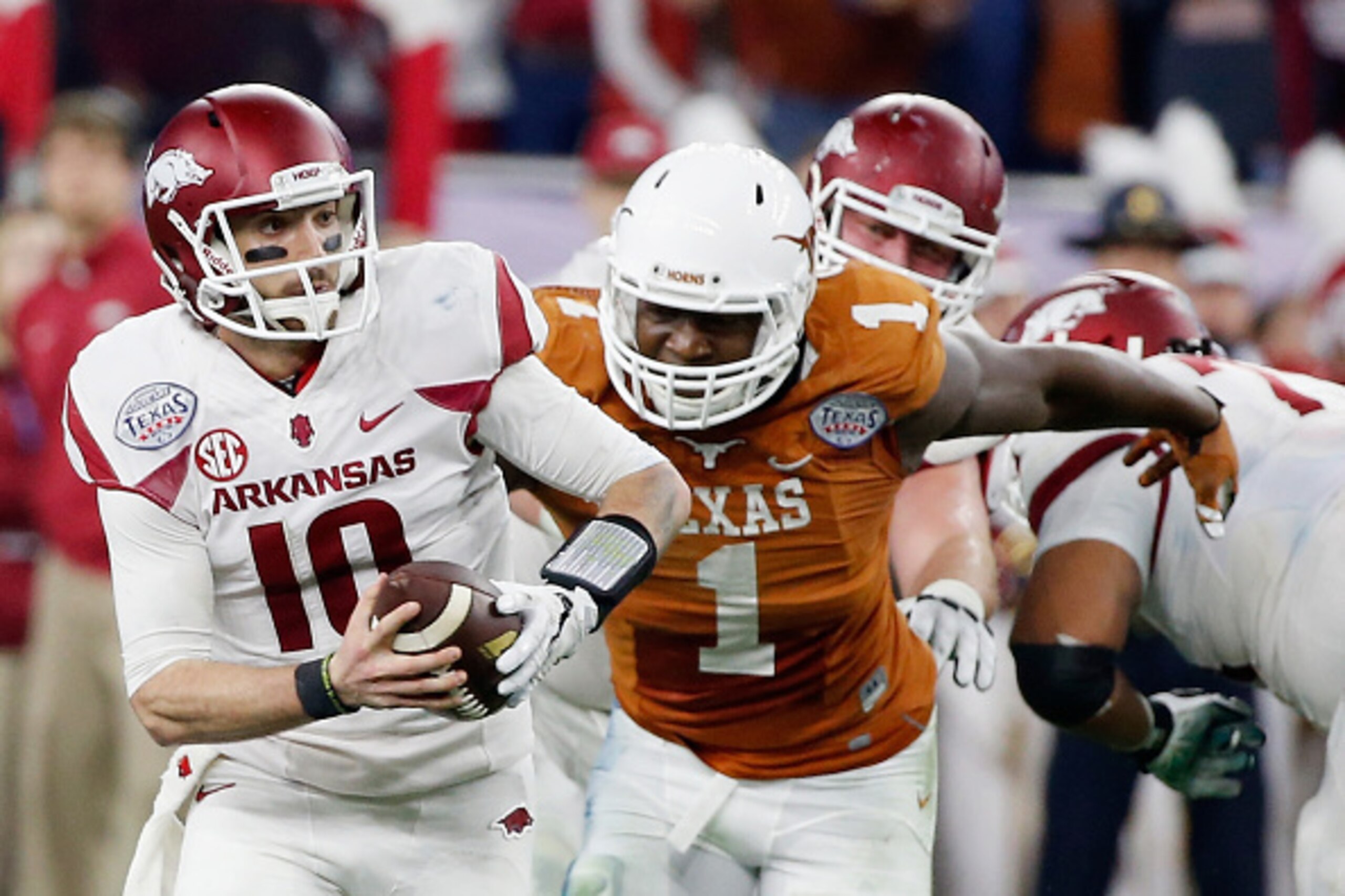 HOUSTON, TX - DECEMBER 29:  Brandon Allen #10 of the Arkansas Razorbacks runs with the ball in the first half of the game against Shiro Davis #1 of the Texas Longhorns at the AdvoCare V100 Texas Bowl at NRG Stadium on December 29, 2014 in Houston, Texas. 