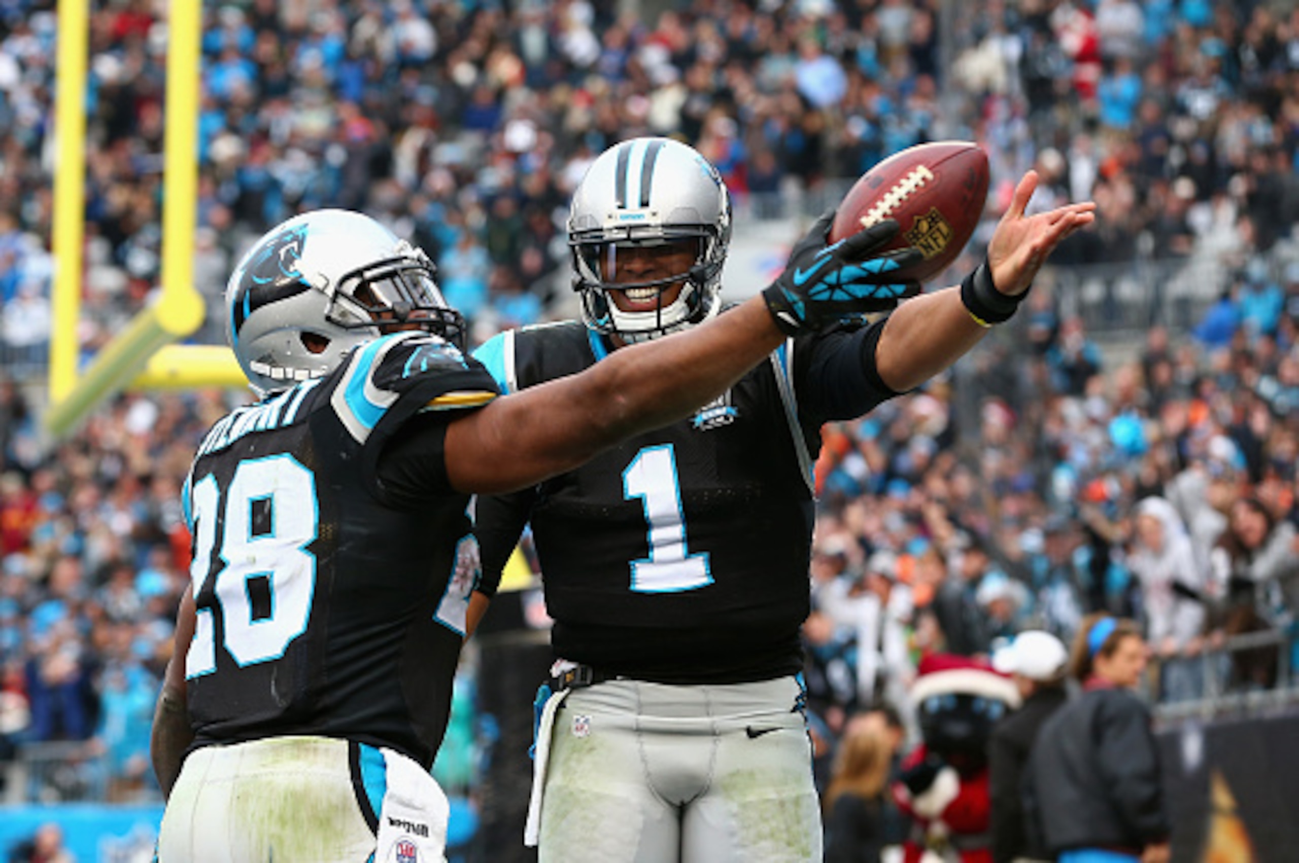 CHARLOTTE, NC - DECEMBER 21:  Cam Newton #1 helps Jonathan Stewart #28 of the Carolina Panthers celebrate his 4th quarter touchdown against the Cleveland Browns during their game at Bank of America Stadium on December 21, 2014 in Charlotte, North Carolina
