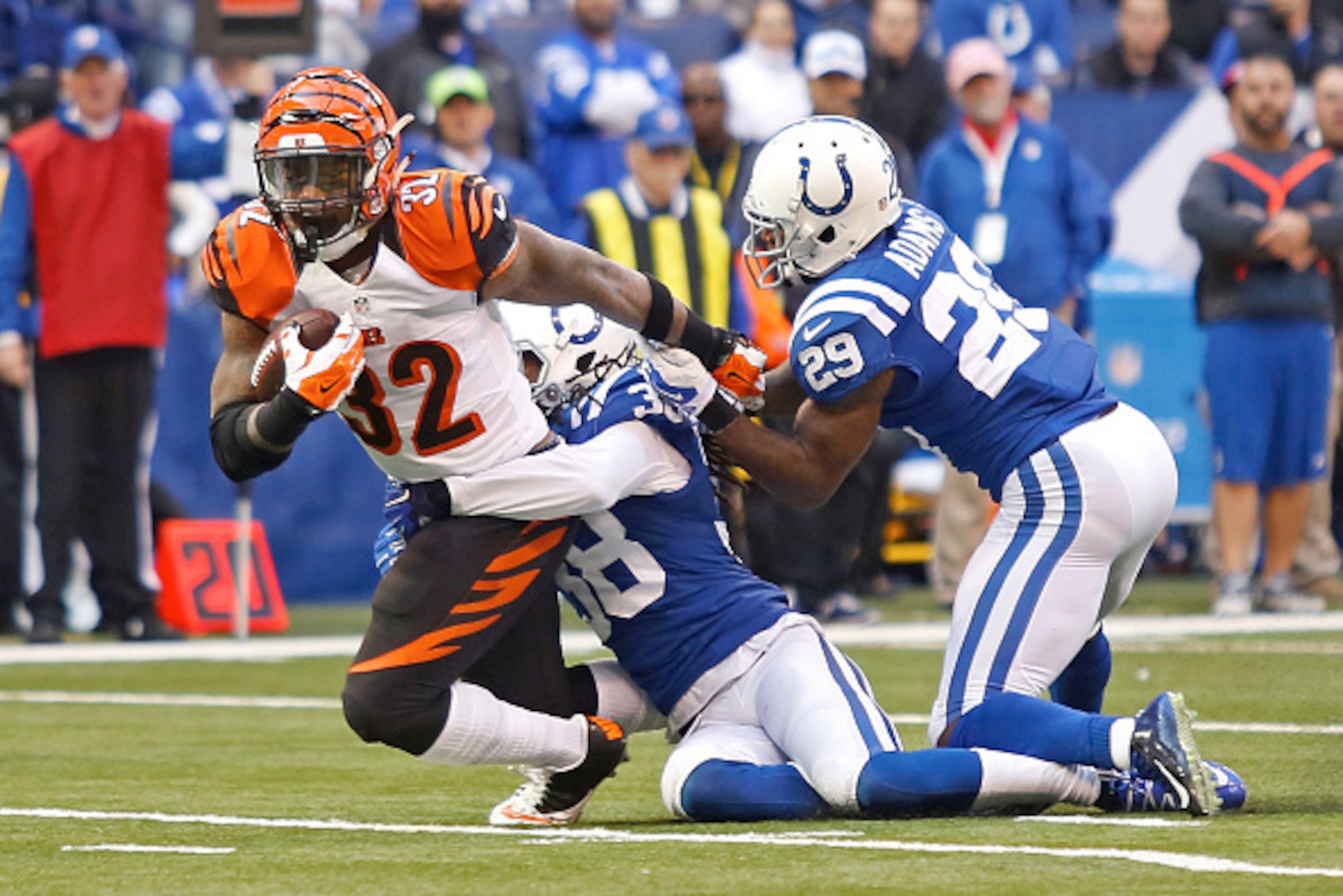 INDIANAPOLIS, IN - OCTOBER 19:  Jeremy Hill #32 of the Cincinnati Bengals is tackled by Sergio Brown #38 of the Indianapolis Colts and Mike Adams #29 of the Indianapolis Colts during the fourth quarter on October 19, 2014 at Lucas Oil Stadium on October 1