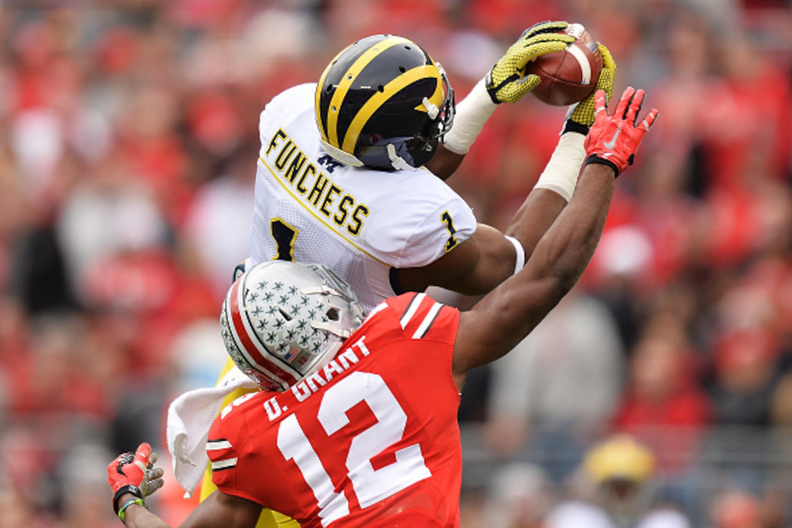 COLUMBUS, OH - NOVEMBER 29:  Devin Funchess #1 of the Michigan Wolverines catches a 45-yard pass in front of Doran Grant #12 of the Ohio State Buckeyes in the first quarter at Ohio Stadium on November 29, 2014 in Columbus, Ohio.  (Photo by Jamie Sabau/Get