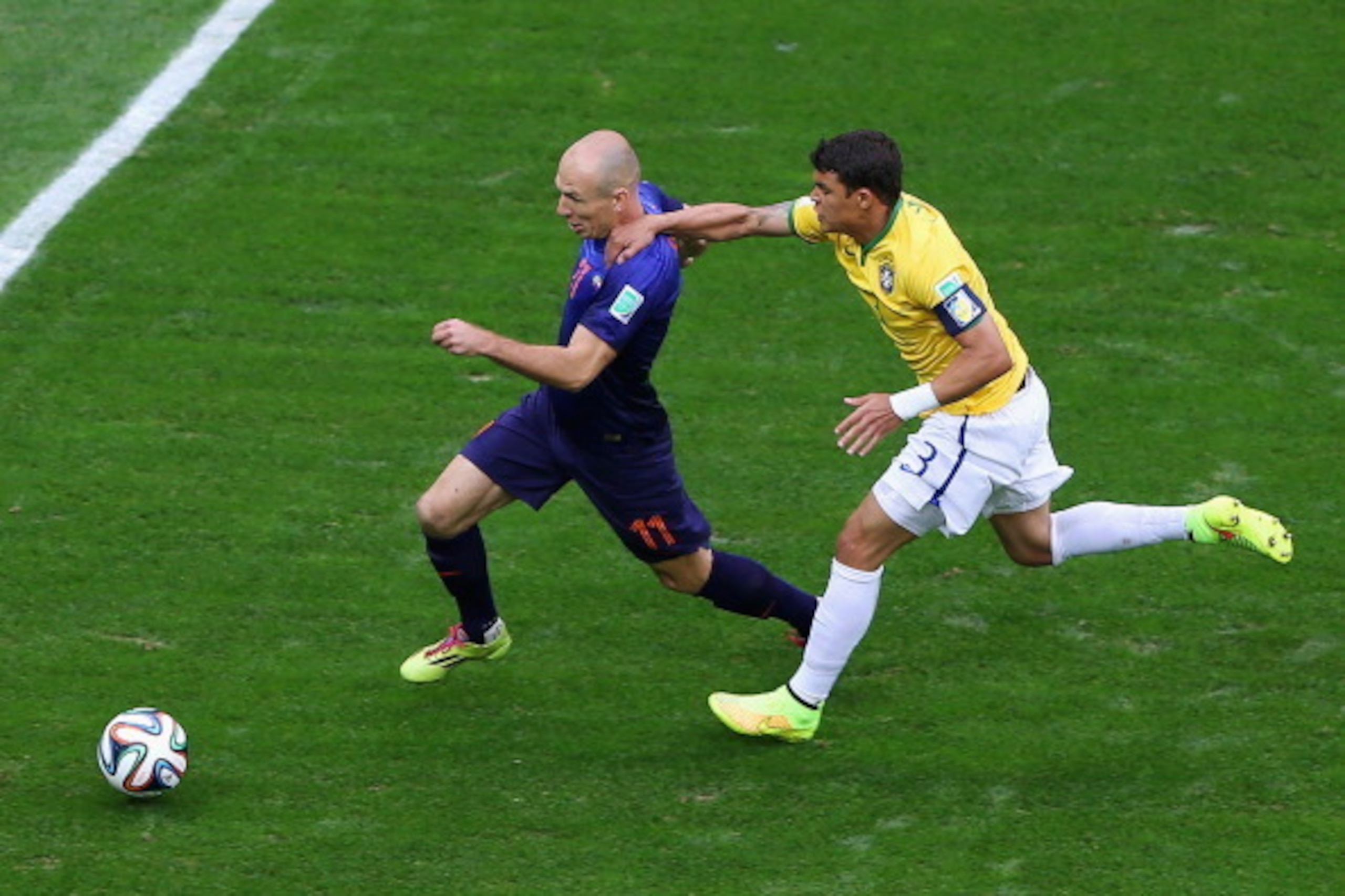 BRASILIA, BRAZIL - JULY 12:  Thiago Silva of Brazil challenges Arjen Robben of the Netherlands resulting in a penalty kick for the Netherlands and yellow card for Silva during the 2014 FIFA World Cup Brazil Third Place Playoff match between Brazil and the