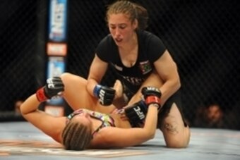 Jul 6, 2014; Las Vegas, NV, USA; Sarah Moras (red gloves) is pinned down by Alexis Dufresne (blue gloves) during a women's bantamweight fight at Mandalay Bay Events Center. Mandatory Credit: Stephen R. Sylvanie-USA TODAY Sports