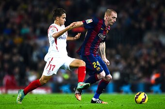 BARCELONA, SPAIN - NOVEMBER 22:  Jeremy Mathieu of FC Barcelona competes for the ball with Denis Suarez of Sevilla FC during the La Liga match between FC Barcelona and Sevilla FC at Camp Nou on November 22, 2014 in Barcelona, Spain.  (Photo by David Ramos