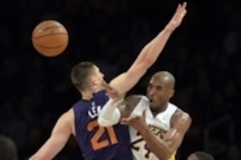 Dec 28, 2014; Los Angeles, CA, USA; Los Angeles Lakers guard Kobe Bryant (24) passes against Phoenix Suns center Alex Len (21) during the first half at Staples Center. Mandatory Credit: Richard Mackson-USA TODAY Sports