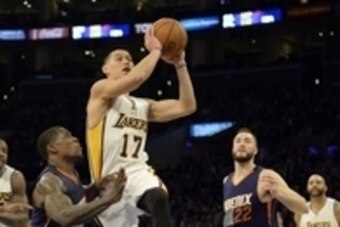 Dec 28, 2014; Los Angeles, CA, USA; Los Angeles Lakers guard Jeremy Lin (17) shoots against Phoenix Suns guard Eric Bledsoe (2) and center Miles Plumlee (22) during the second half at Staples Center. Mandatory Credit: Richard Mackson-USA TODAY Sports