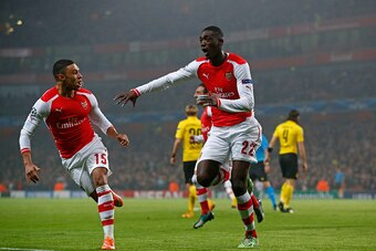LONDON, ENGLAND - NOVEMBER 26:  Yaya Sanogo (R) of Arsenal celebrates with teammate Alex Oxlade-Chamberlain (L) after scoring the opening goal during the UEFA Champions League Group D match between Arsenal and Borussia Dortmund at the Emirates Stadium on 