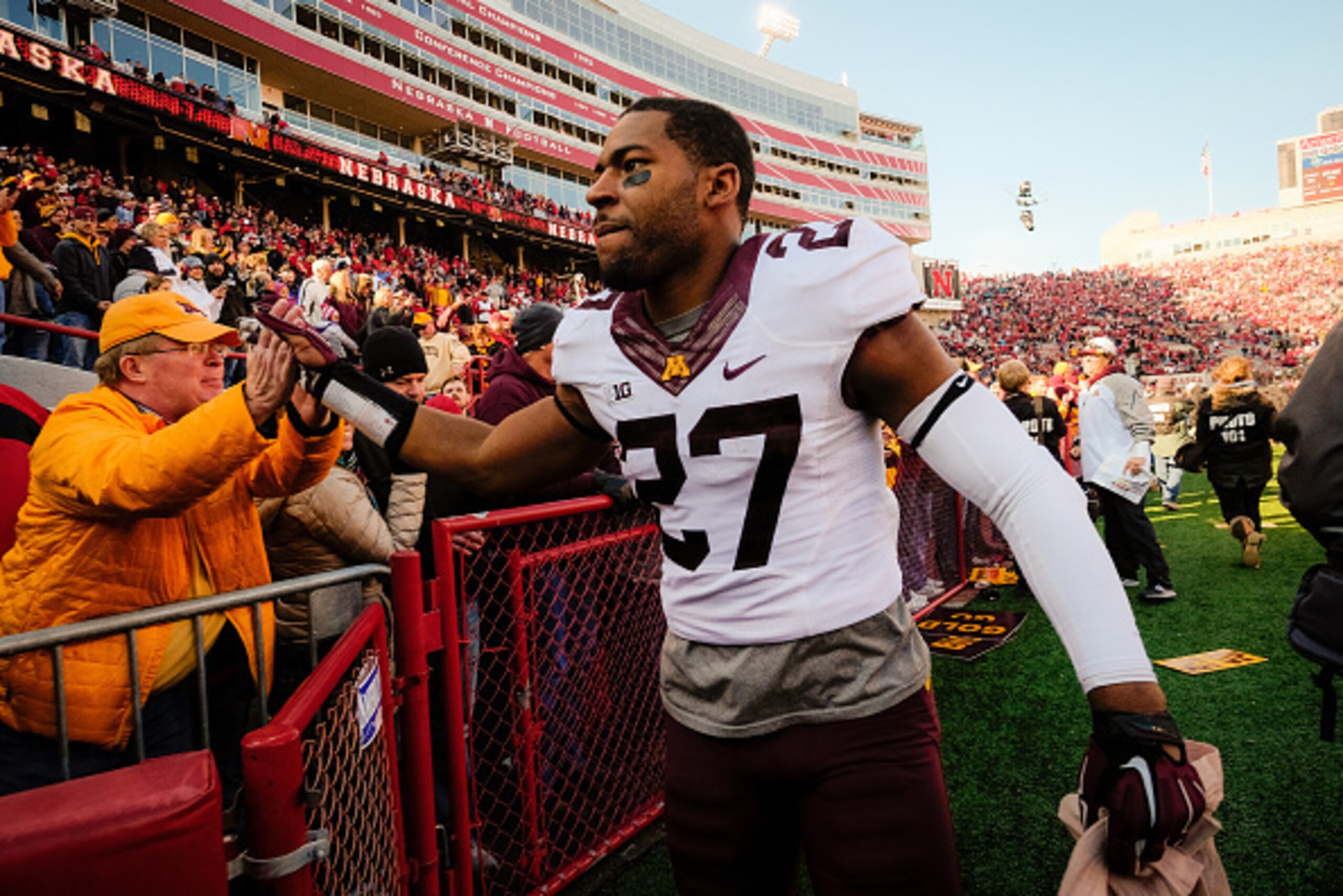 LINCOLN, NE - NOVEMBER 22: Running back David Cobb #27 of the Minnesota Golden Gophers shakes receiving congratulations from fans after their game against the Nebraska Cornhuskers at Memorial Stadium on November 22, 2014 in Lincoln, Nebraska. Minnesota de
