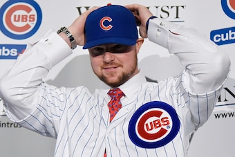 CHICAGO, IL - DECEMBER 15:  Pitcher Jon Lester puts on a Cubs hat during an introduction press conference by the Chicago Cubs on December 15, 2014  in Chicago, Illinois. (Photo by David Banks/Getty Images)