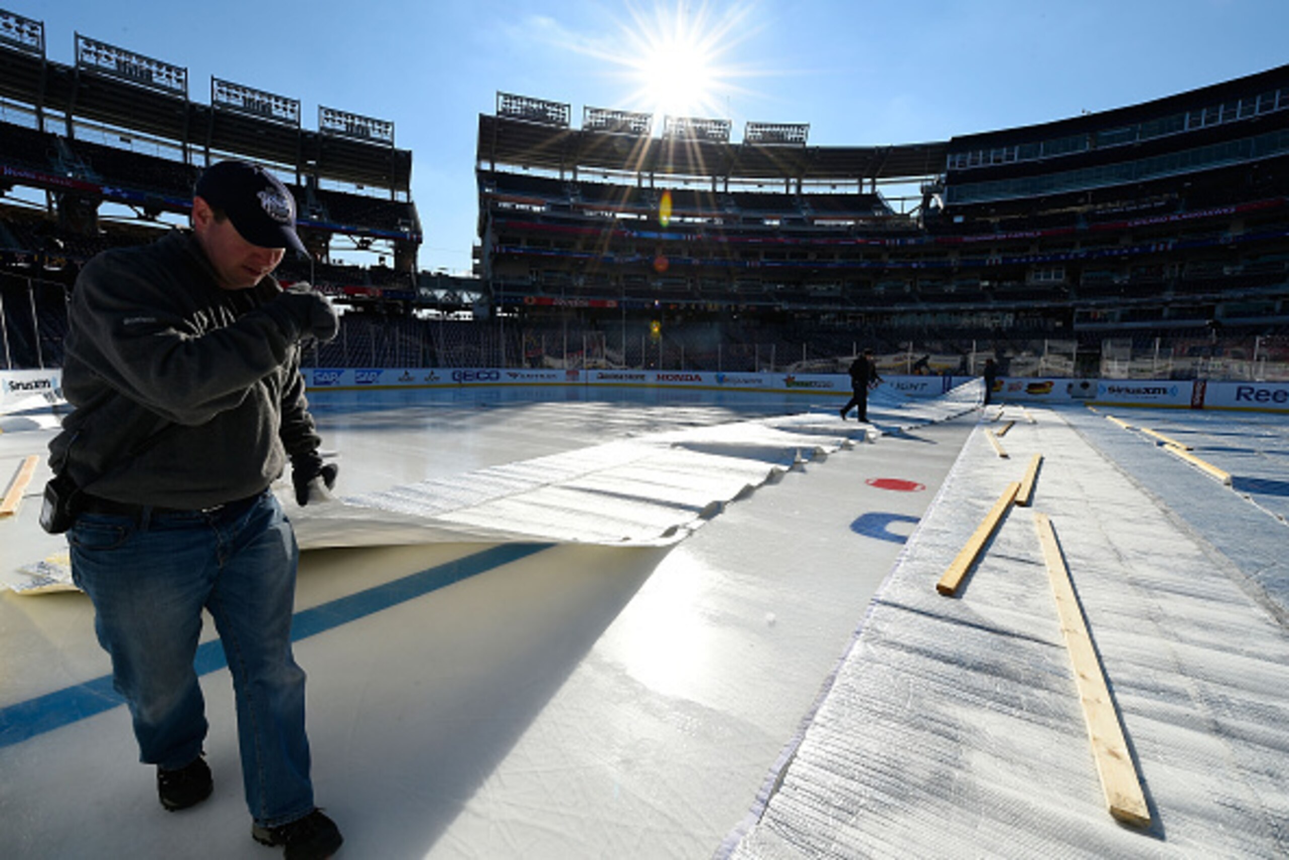 WASHINGTON, DC - DECEMBER 30:  Members of the ice crew cover the ice during the 2015 Bridgestone NHL Winter Classic Build Out on December 30, 2014 at Nationals Park in Washington, D.C.  The 2015 NHL Winter Classic will take place on New Year's Day with th