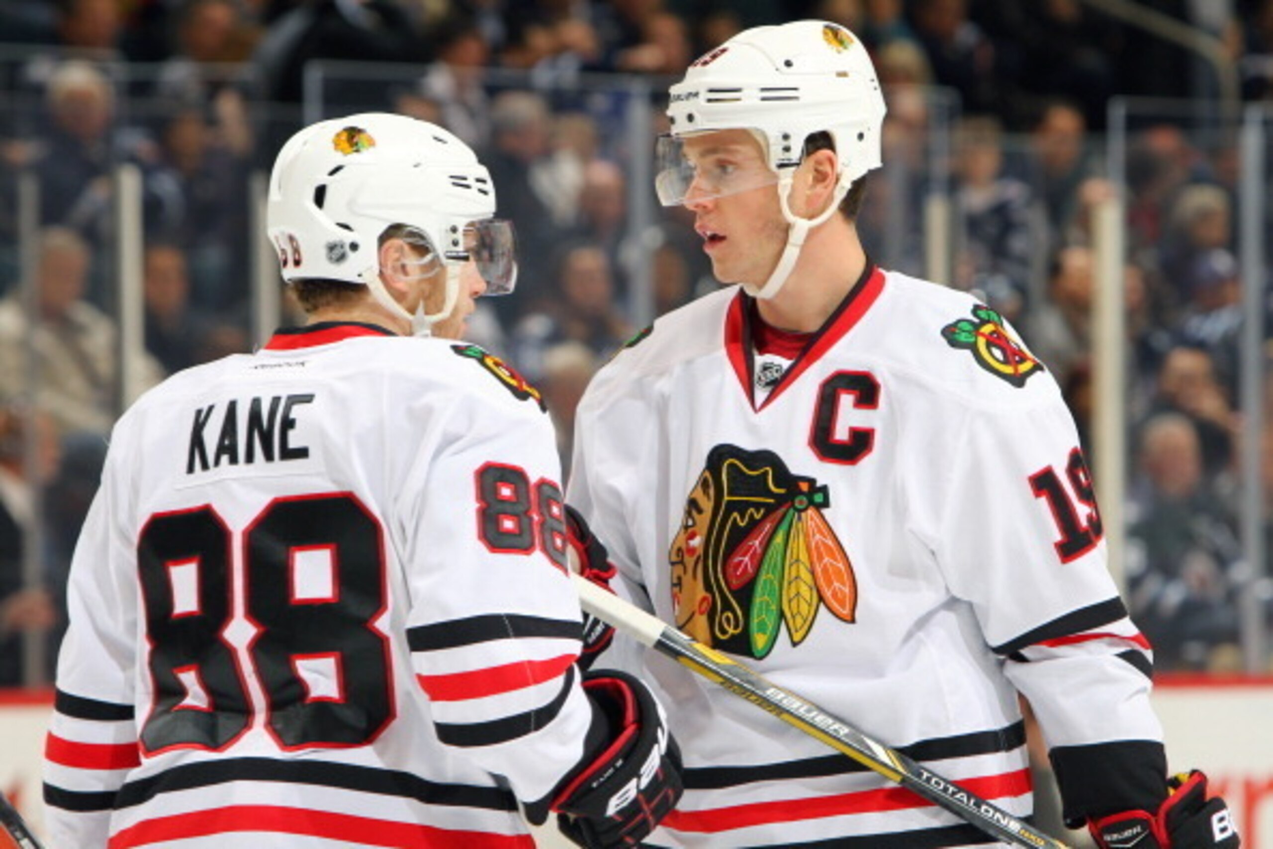 WINNIPEG, MB - NOVEMBER 21: Patrick Kane #88 and Jonathan Toews #19 of the Chicago Blackhawks discuss strategy during first period action against the Winnipeg Jets at the MTS Centre on November 21, 2013 in Winnipeg, Manitoba, Canada. (Photo by Jonathan Ko