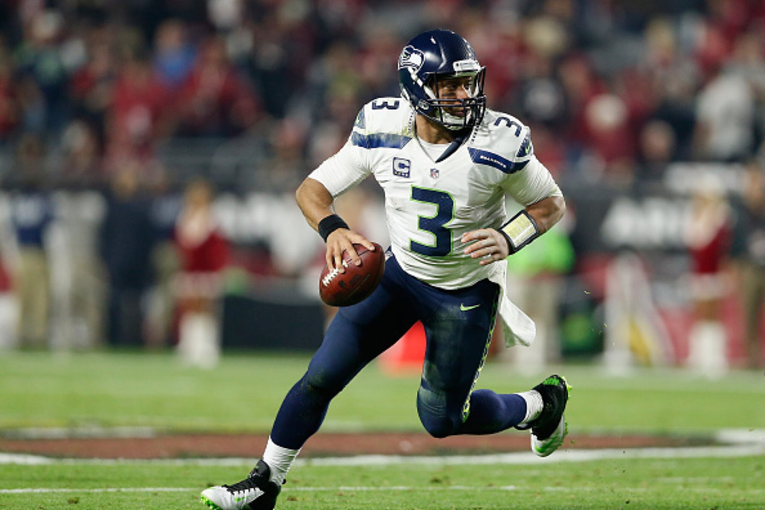 GLENDALE, AZ - DECEMBER 21:  Quarterback Russell Wilson #3 of the Seattle Seahawks scrambles with the football during the NFL game against the Arizona Cardinals at the University of Phoenix Stadium on December 21, 2014 in Glendale, Arizona.  The Seahawks 