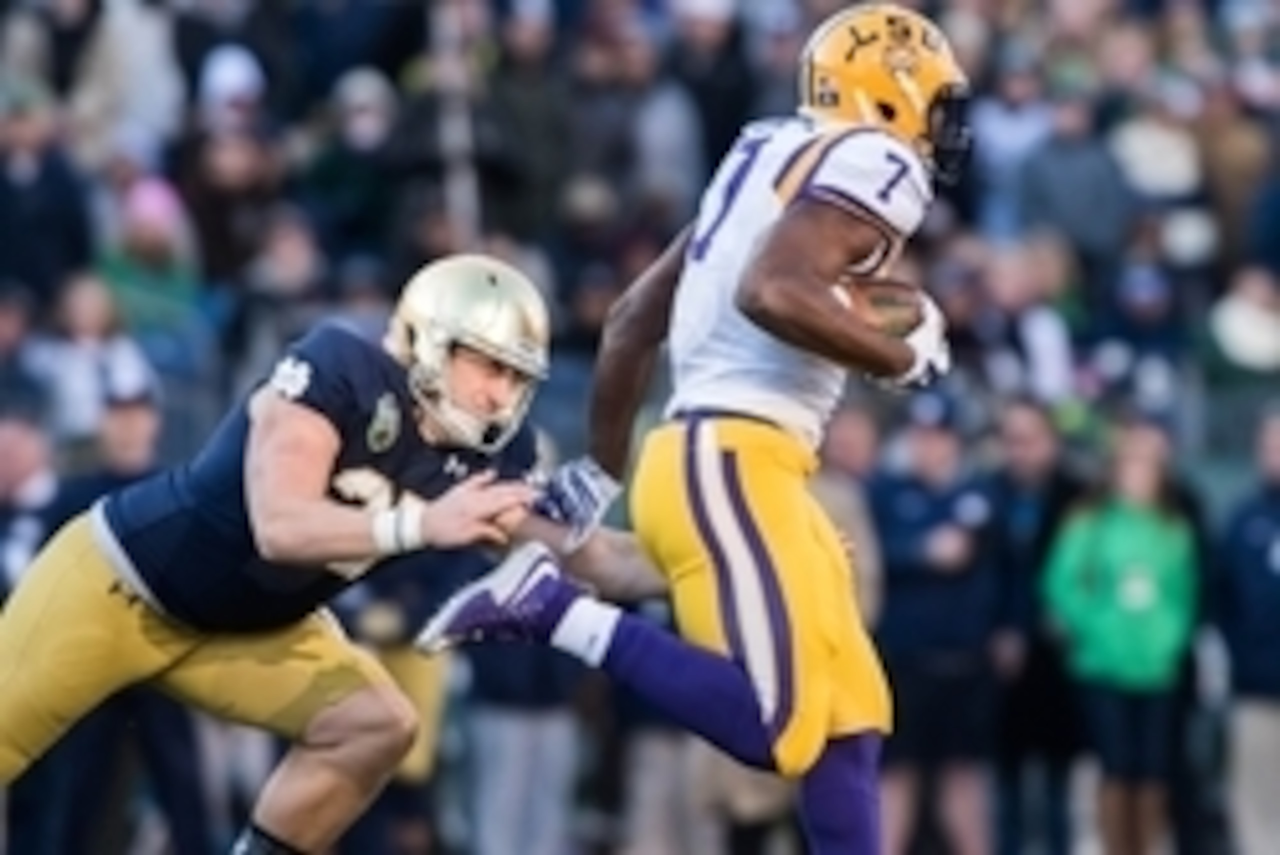 Dec 30, 2014; Nashville, TN, USA; Notre Dame Fighting Irish kicker Kyle Brindza (27) attempts to tackle Louisiana State Tigers running back Leonard Fourenette (7) on a kickoff return in the second quarter at LP Field. Fournette scored a touchdown on the p