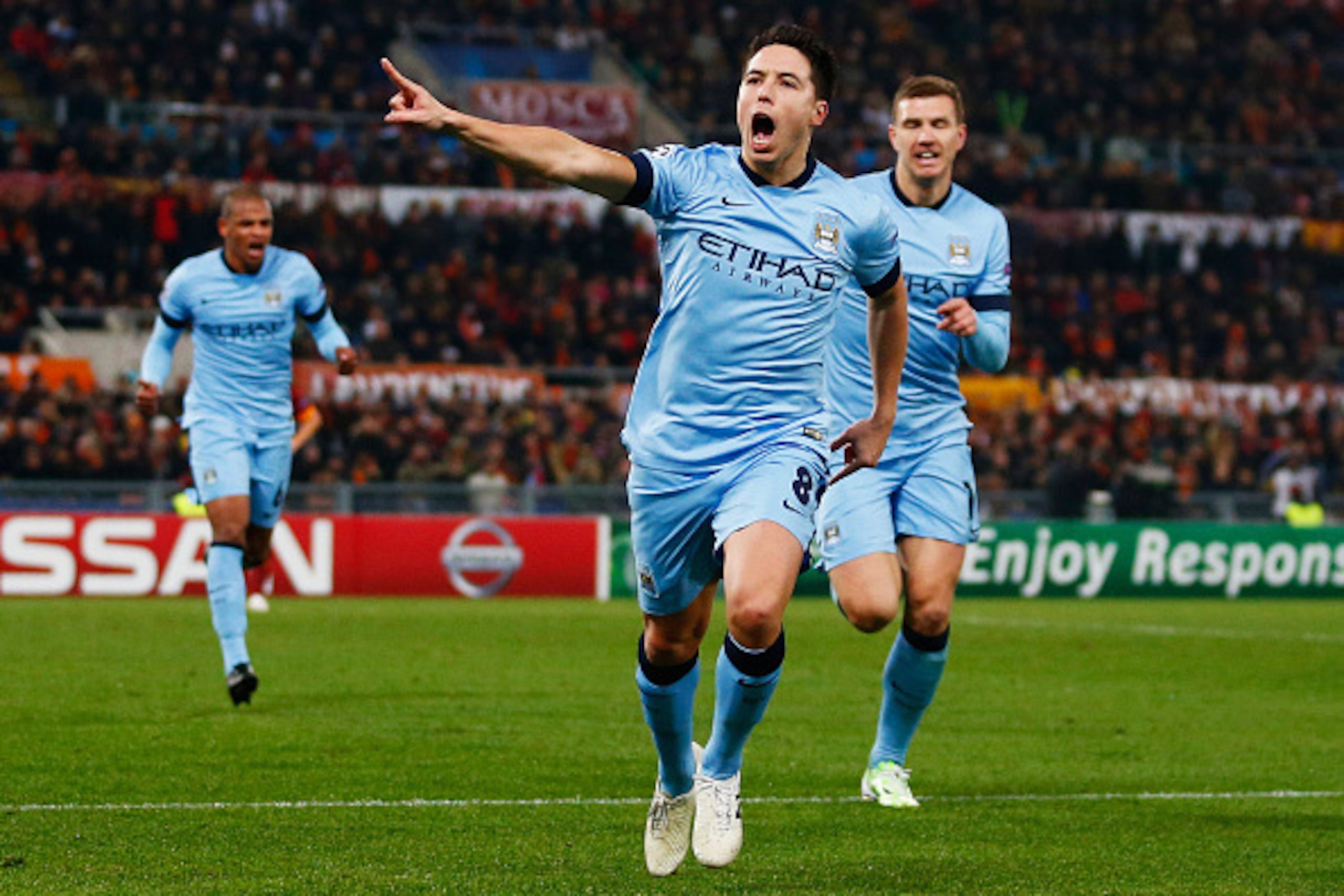 ROME, ITALY - DECEMBER 10: Samir Nasri of Manchester City (8) celebrates with Edin Dzeko as he scores their first goal during the UEFA Champions League Group E match between AS Roma and Manchester City FC at Stadio Olimpico on December 10, 2014 in Rome, ROME, ITALY - DECEMBER 10: Samir Nasri of Manchester City (8) celebrates with Edin Dzeko as he scores their first goal during the UEFA Champions League Group E match between AS Roma and Manchester City FC at Stadio Olimpico on December 10, 2014 in Rome,