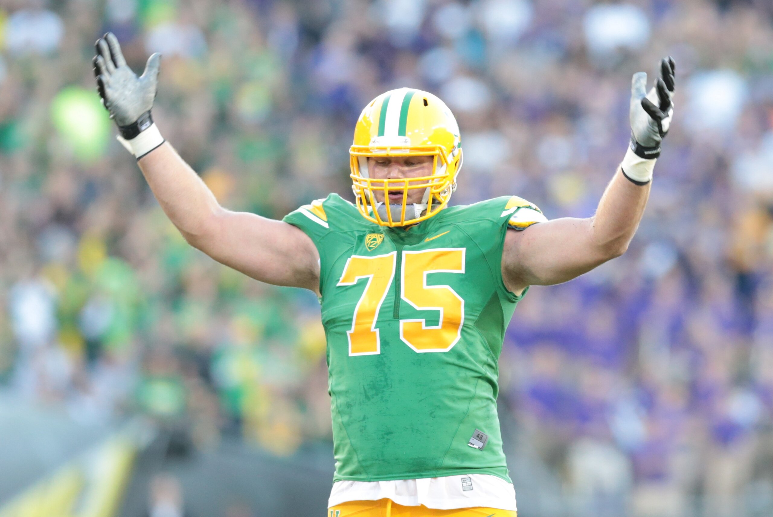 Oct 18, 2014; Eugene, OR, USA; Oregon Ducks offensive lineman Jake Fisher (75) motivates the crowd against the Washington Huskies at Autzen Stadium. Mandatory Credit: Scott Olmos-USA TODAY Sports