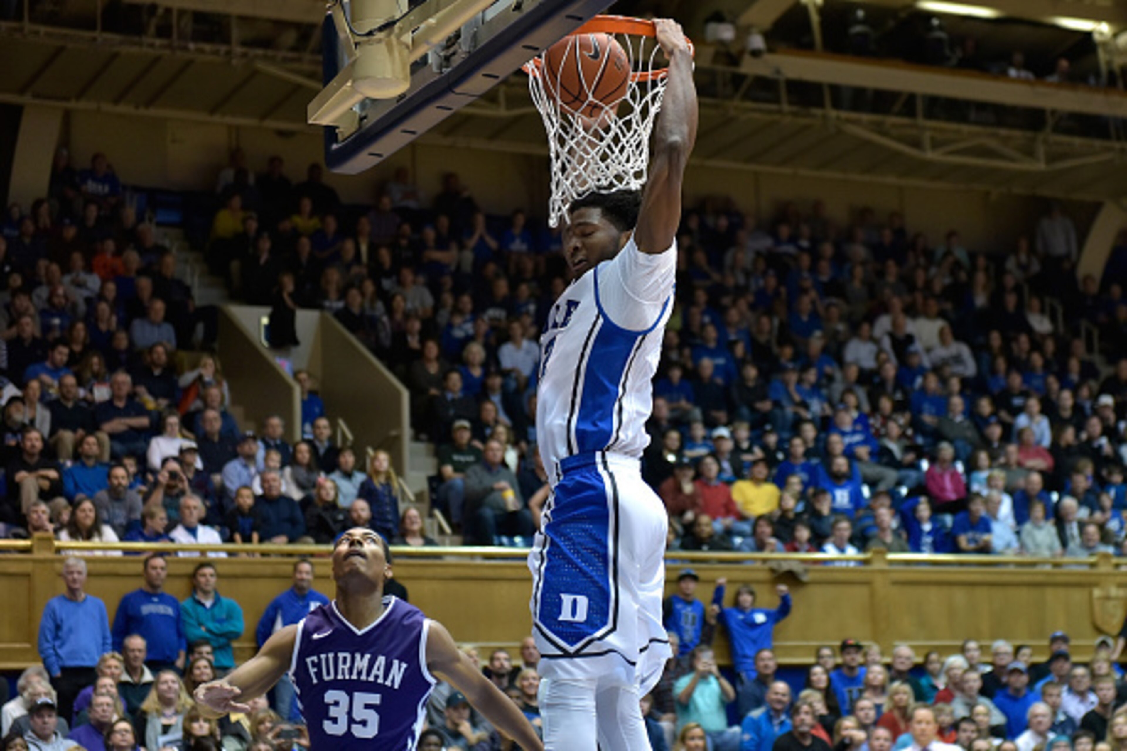 DURHAM, NC - NOVEMBER 26: Justise Winslow #12 of the Duke Blue Devils dunks over Daniel Fowler #35 of the Furman Paladins during their game at Cameron Indoor Stadium on November 26, 2014 in Durham, North Carolina. (Photo by Grant Halverson/Getty Images)