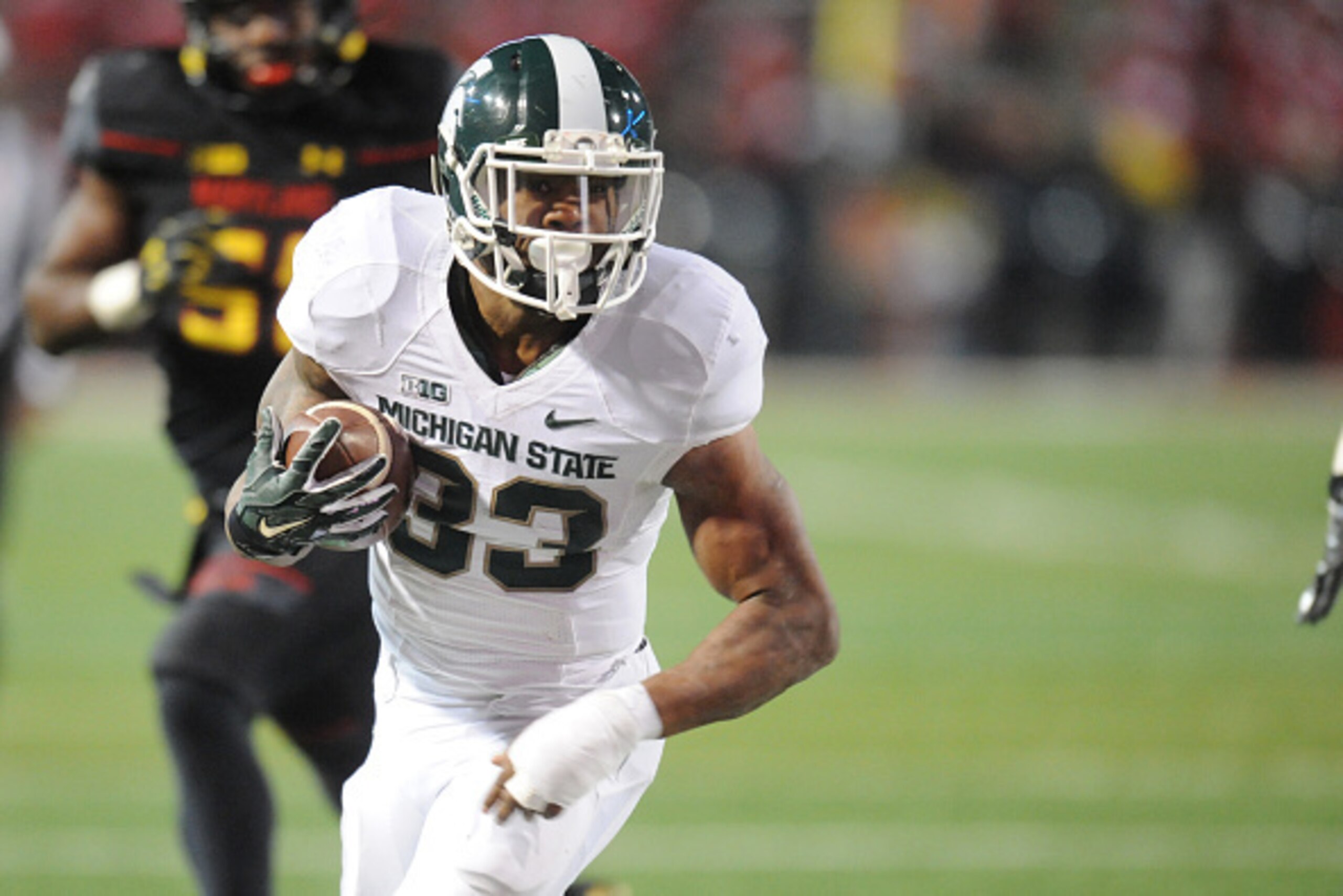 COLLEGE PARK, MD - NOVEMBER 15:  Jeremy Langford #33 of the Michigan State Spartans runs wit the ball during a college football game against the Maryland Terrapins at Byrd Stadium on November 15, 2014 in College Park, Maryland.  The Spartans won 37-15.  (