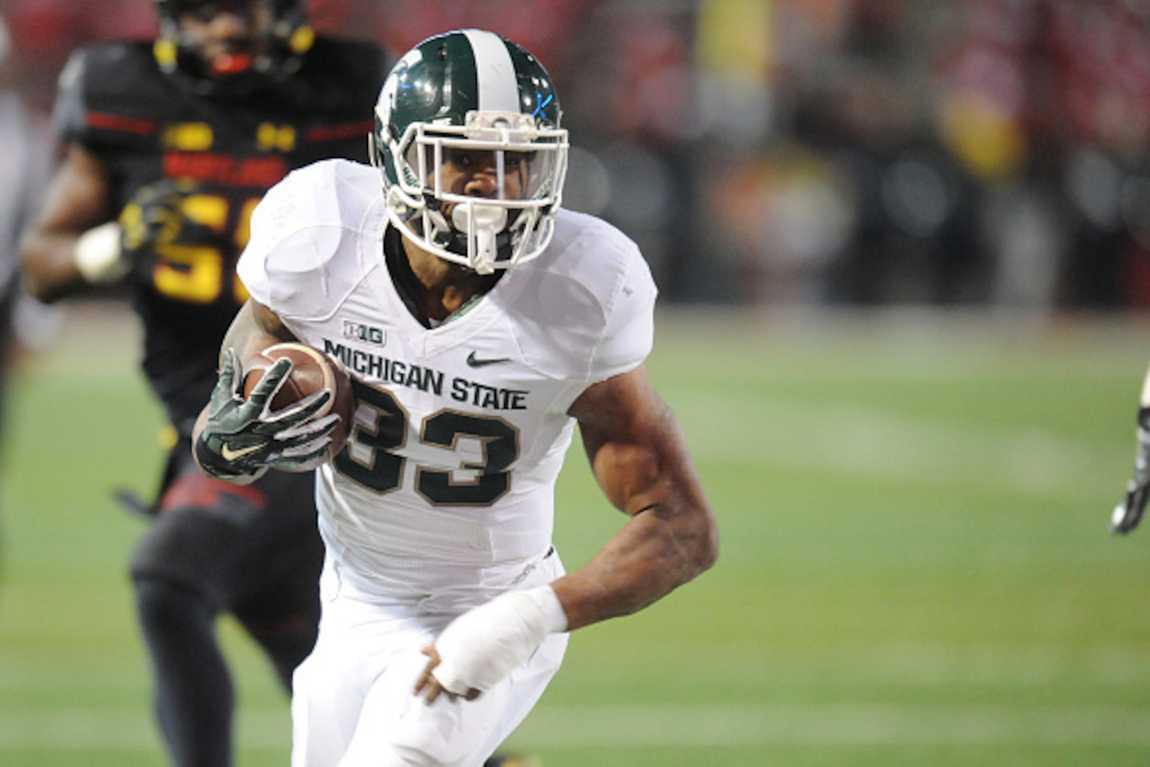 COLLEGE PARK, MD - NOVEMBER 15:  Jeremy Langford #33 of the Michigan State Spartans runs wit the ball during a college football game against the Maryland Terrapins at Byrd Stadium on November 15, 2014 in College Park, Maryland.  The Spartans won 37-15.  (