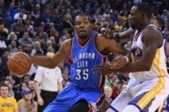 December 18, 2014; Oakland, CA, USA; Oklahoma City Thunder forward Kevin Durant (35) dribbles the basketball against Golden State Warriors forward Draymond Green (23) during the second quarter at Oracle Arena. The Warriors defeated the Thunder 114-109. Ma