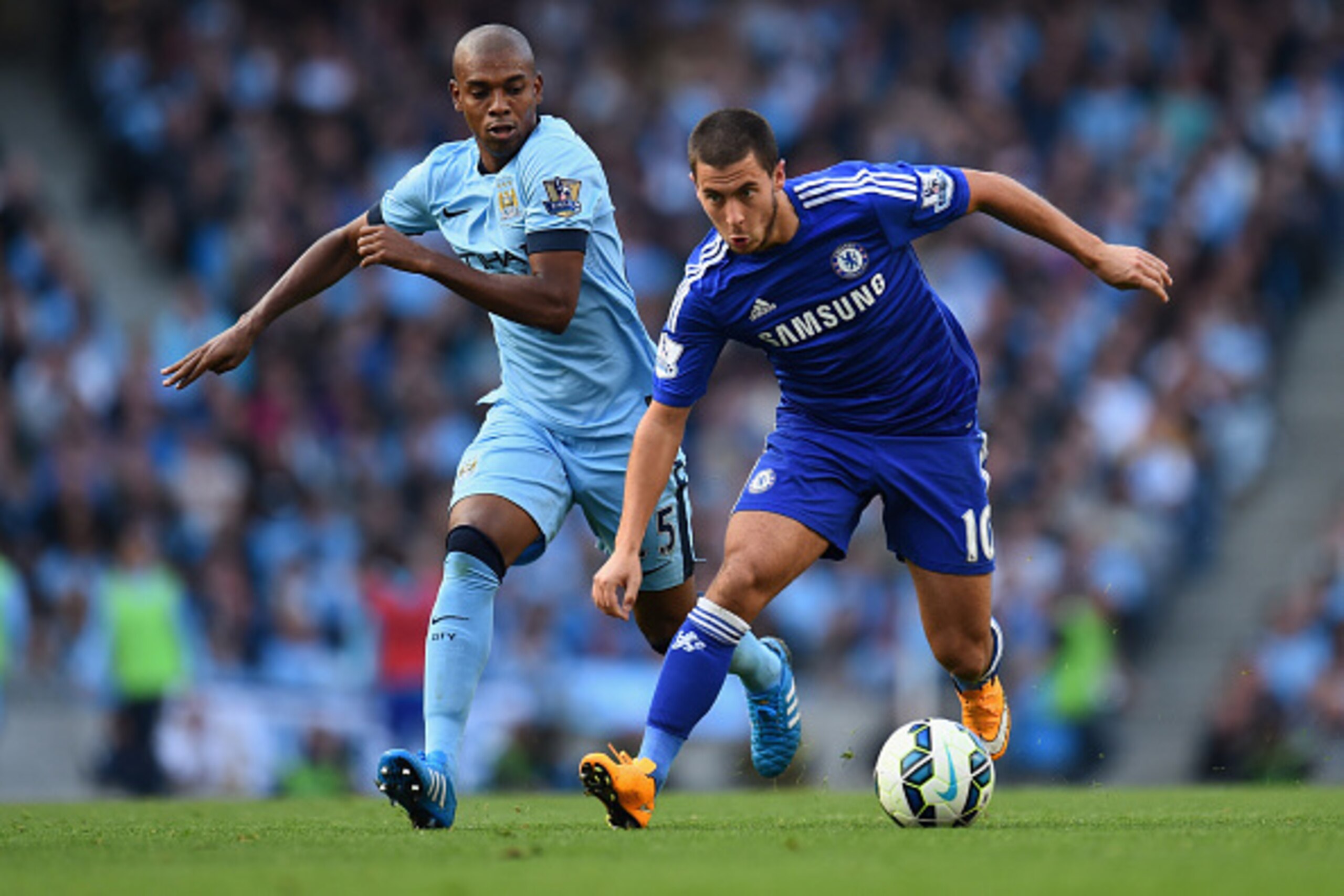 MANCHESTER, ENGLAND - SEPTEMBER 21:  Eden Hazard of Chelsea competes with Fernandinho of Manchester City during the Barclays Premier League match between Manchester City and Chelsea at the Etihad Stadium on September 21, 2014 in Manchester, England.  (Pho