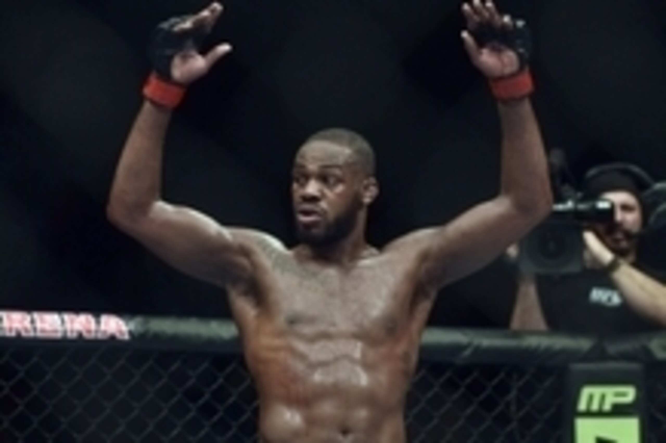 Apr 26, 2014; Baltimore, MD, USA;  Jon Jones puts his arms in the air after the UFC light heavy weight championship fight against Glover Texeira at  Baltimore Arena. Jones retained the light heavy height championship by defeating  Teixeria.  Mandatory Cre