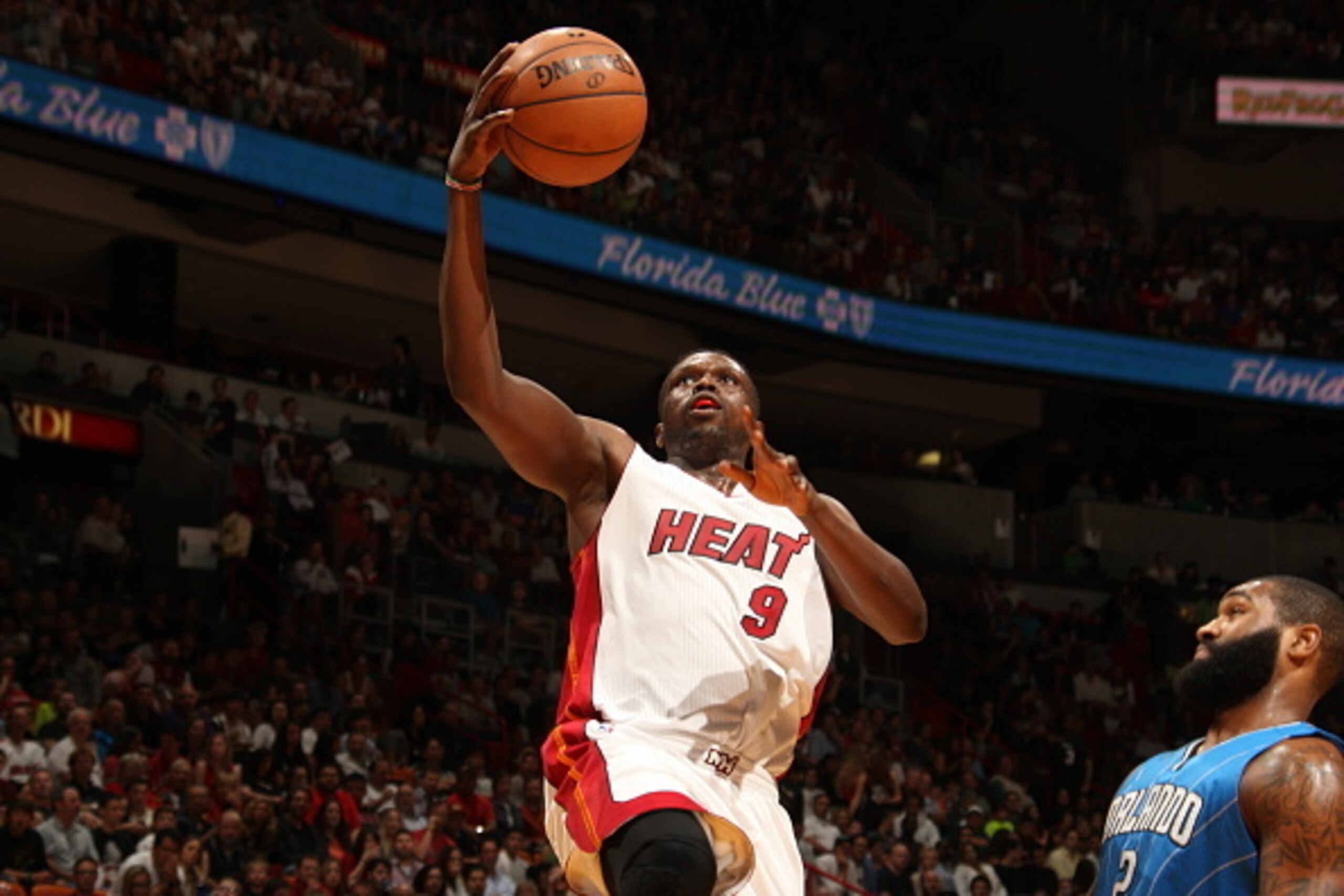 MIAMI, FL - DECEMBER 29:  Luol Deng #9 of the Miami Heat goes to the basket against the Orlando Magic on December 29, 2014 at American Airlines Arena in Miami, Florida.  NOTE TO USER: User expressly acknowledges and agrees that, by downloading and or usin