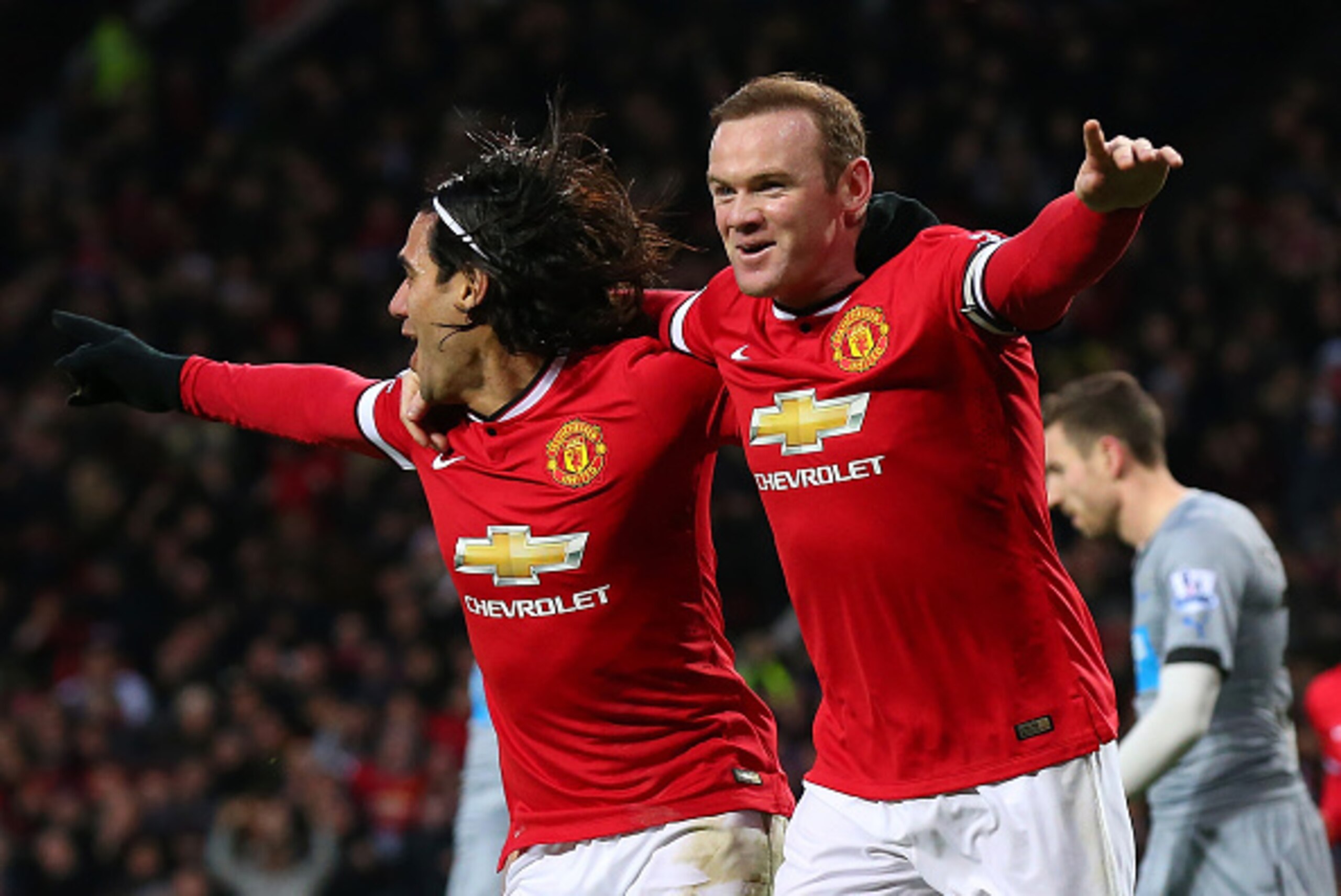 MANCHESTER, ENGLAND - DECEMBER 26:  Wayne Rooney of Manchester United celebrates scoring the first goal with team-mate Radamel Falcao (L) during the Barclays Premier League match between Manchester United and Newcastle United at Old Trafford on December 2