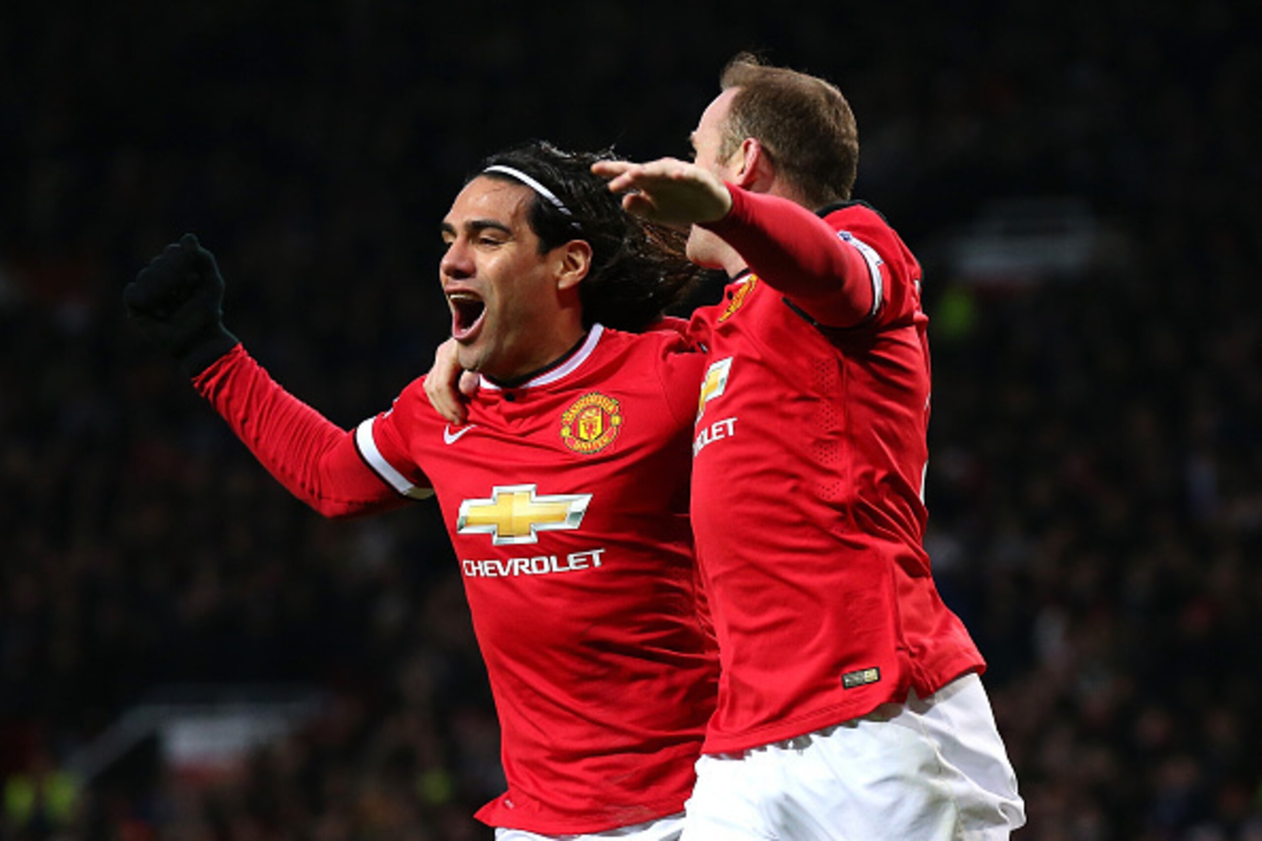 MANCHESTER, ENGLAND - DECEMBER 26:  Wayne Rooney of Manchester United celebrates scoring the first goal with team-mate Radamel Falcao (L) during the Barclays Premier League match between Manchester United and Newcastle United at Old Trafford on December 2